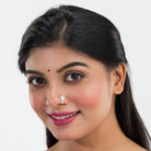 Small oxidized nose pin in silver, perfect for festival wear, adding a delicate vintage touch.
