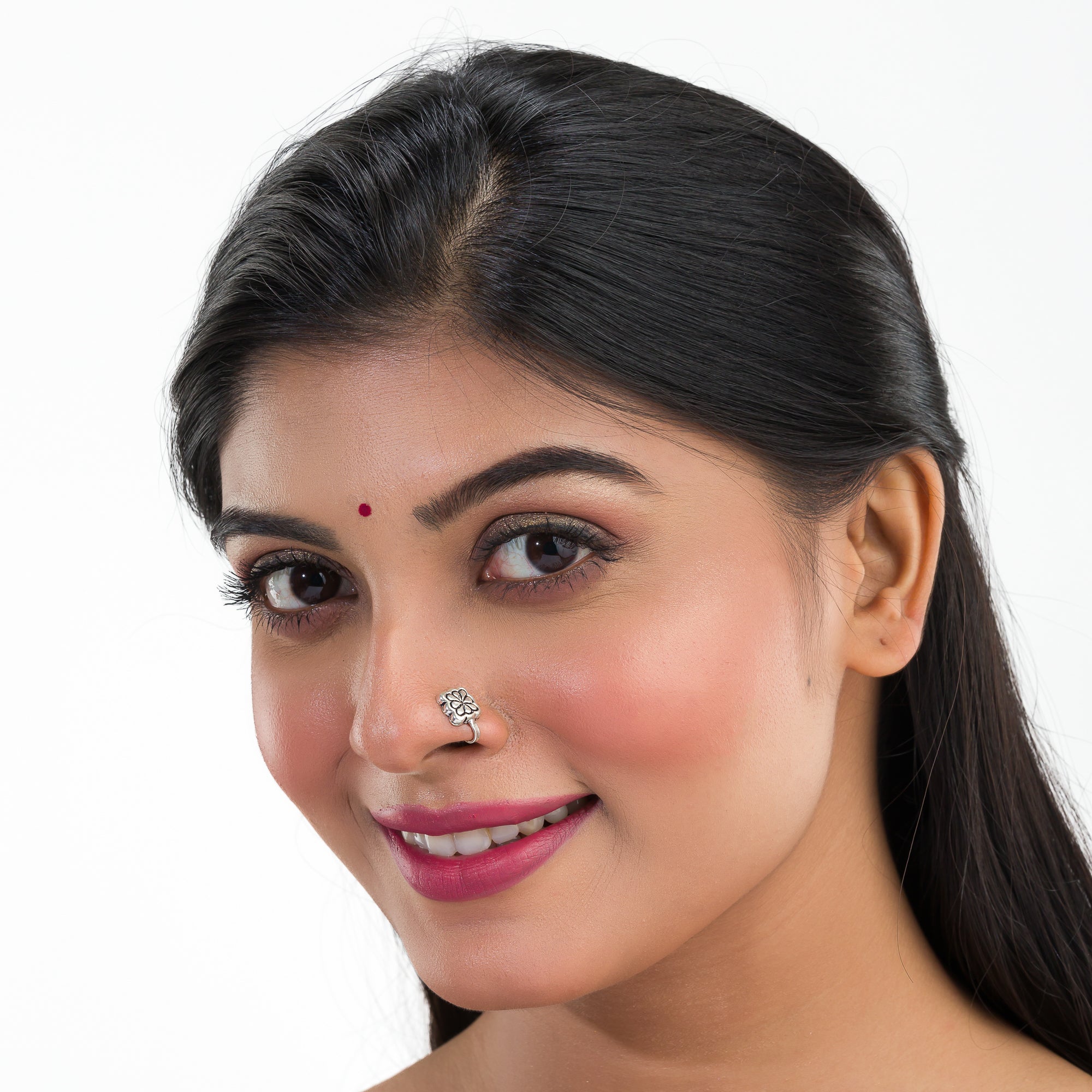 1. "Oxidized silver nose pin, perfect for festival wear, adding an understated, vintage-inspired charm."