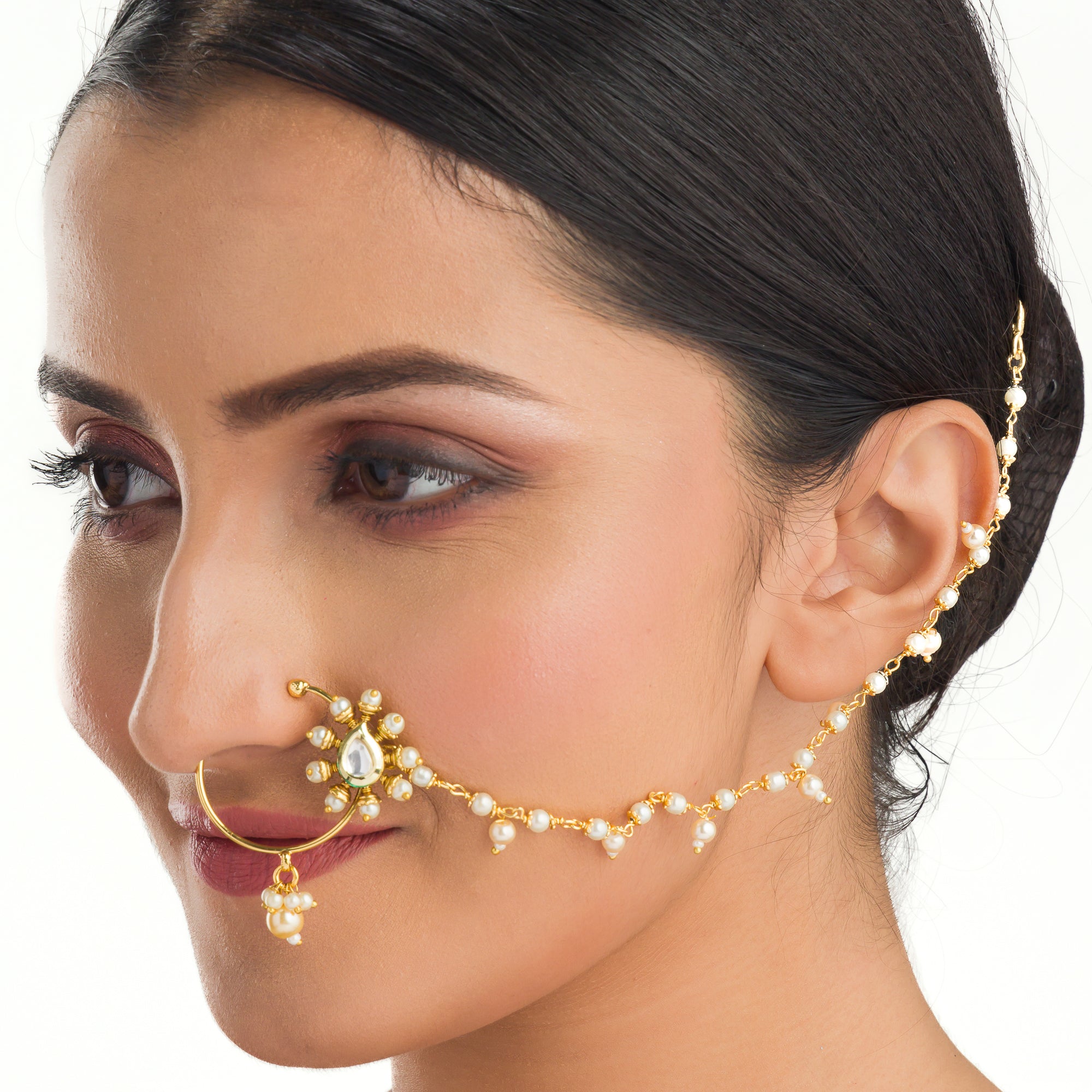 "Elegant gold-tone nose pin with pearls, perfect for festival wear, blending tradition and sophistication."
