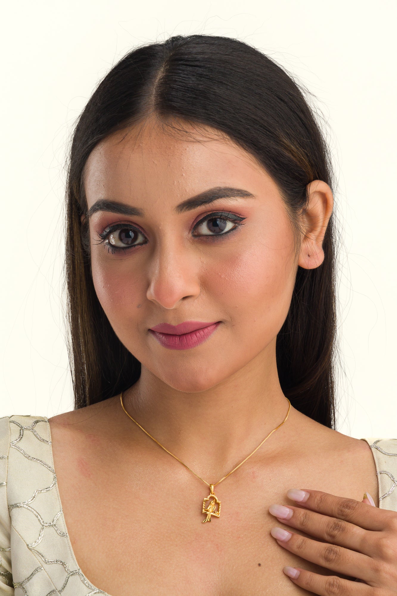 "Charming gold-tone pendant with a bird in a nest, perfect for casual wear, with a warm, elegant finish."