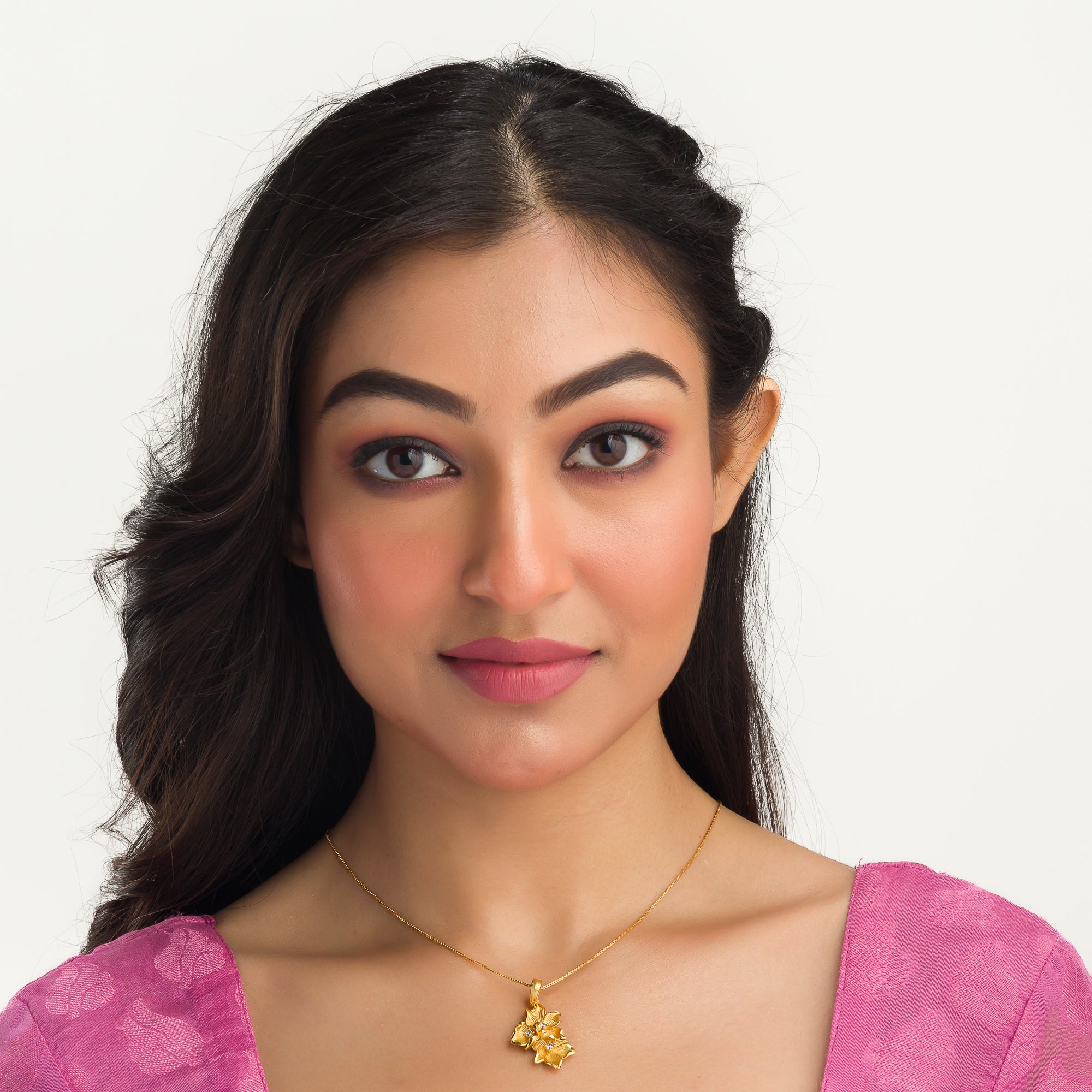 "Gold-tone pendant featuring three flowers, perfect for casual wear, offering a charming, delicate look."