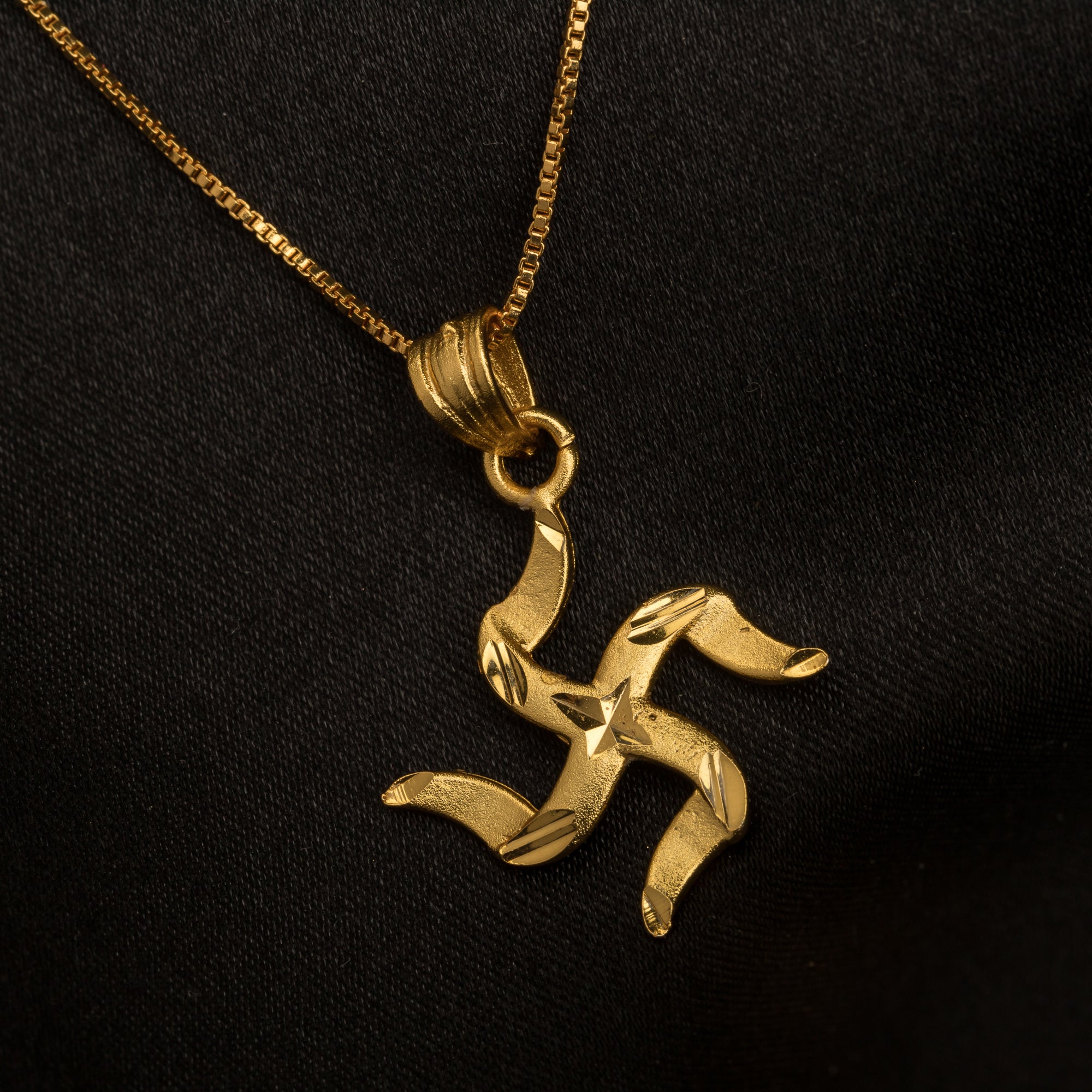 Elegant gold-tone pendant with a Swastik design, perfect for casual wear, adding a meaningful touch."
