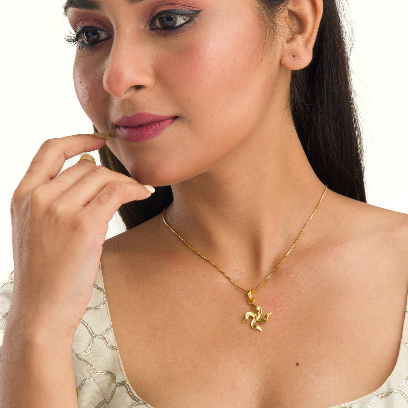 Elegant gold-tone pendant with a Swastik design, perfect for casual wear, adding a meaningful touch."