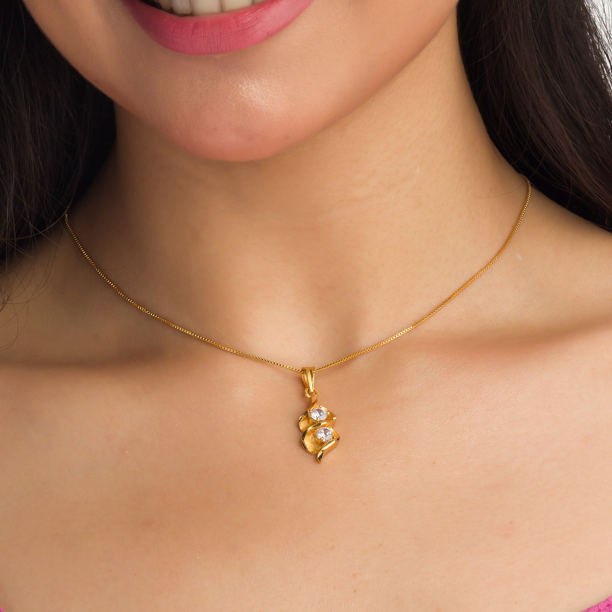 Gold-tone pendant in infinity shape with two stones, perfect for casual wear, adding elegance