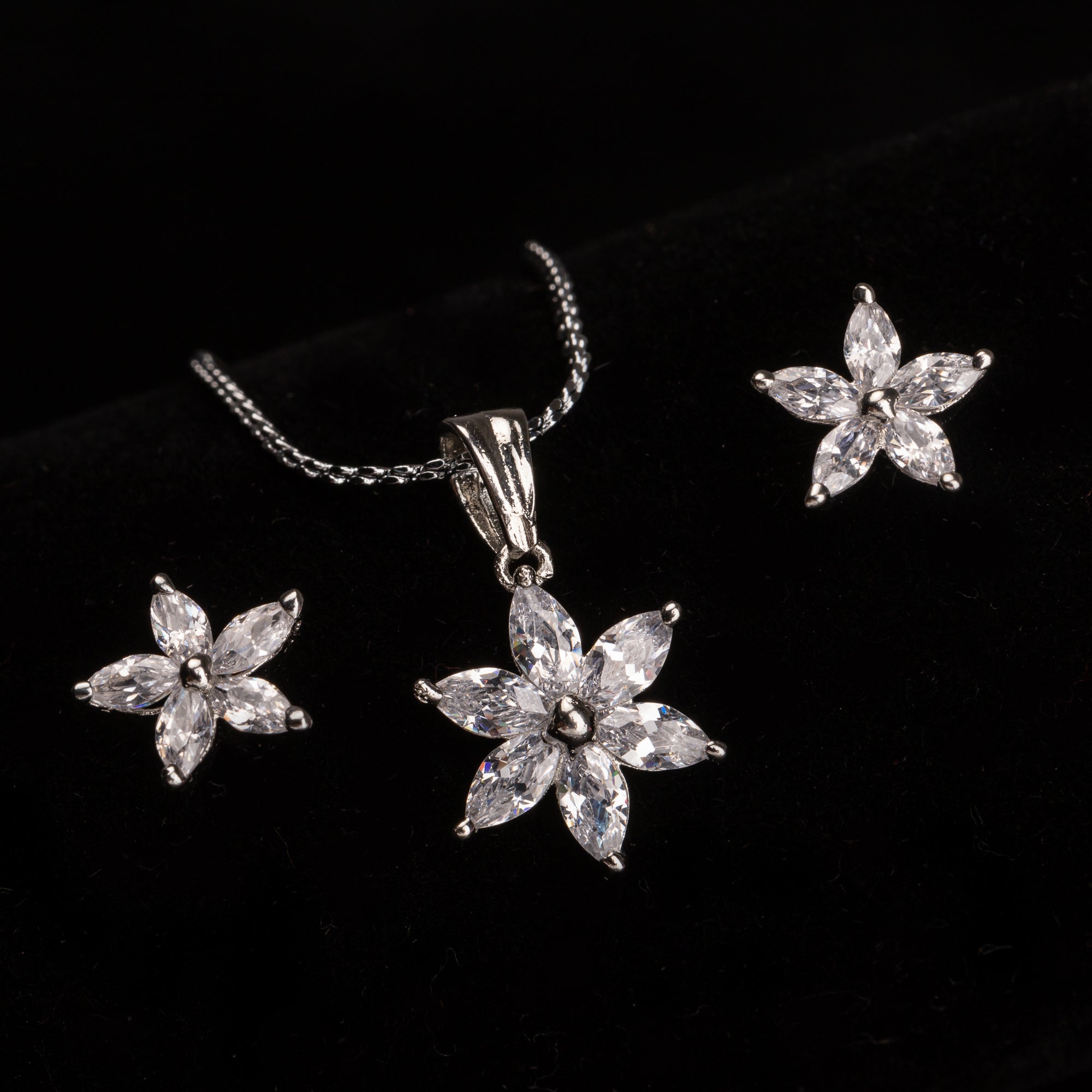 "Star-shaped zircon pendant set for neck and ear, ideal for office wear, adding a modern touch."