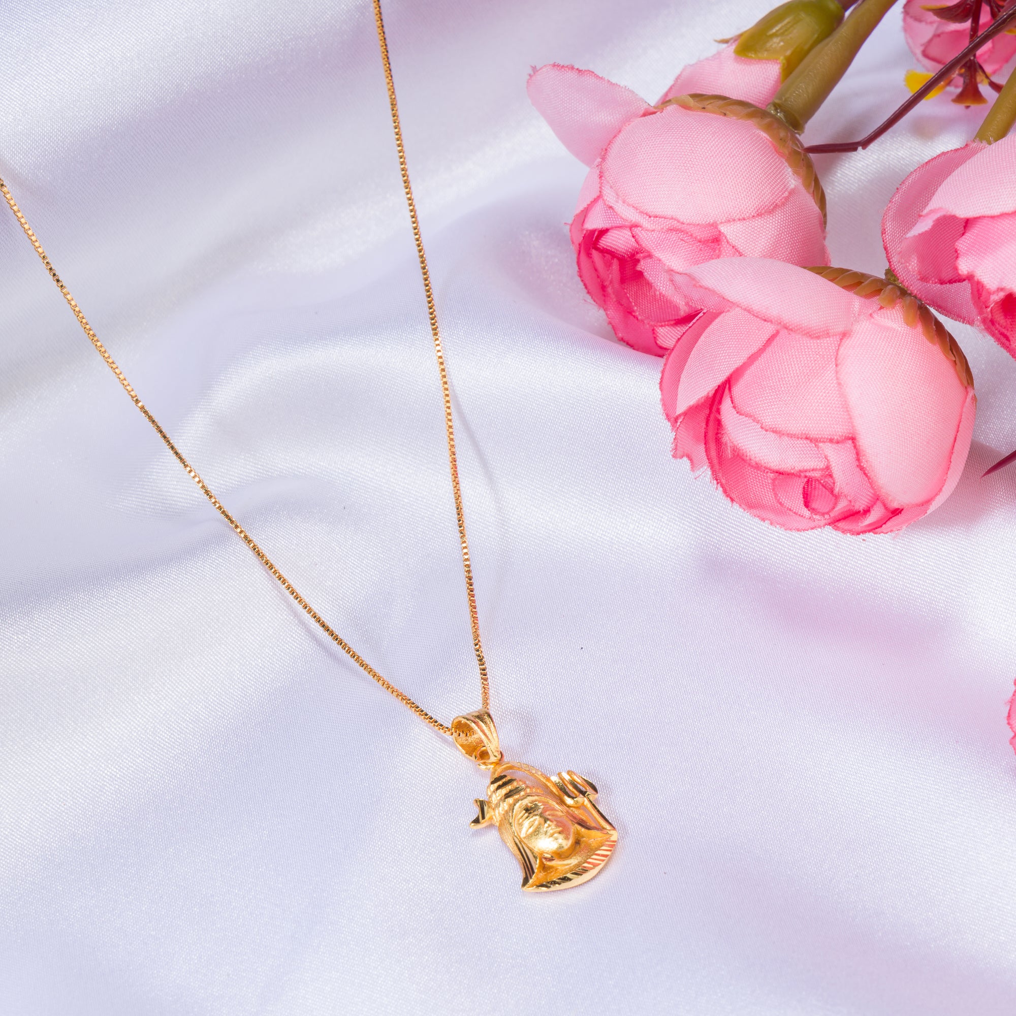 "Gold-tone pendant set featuring Shivji with half moon and trishul, perfect for casual wear."