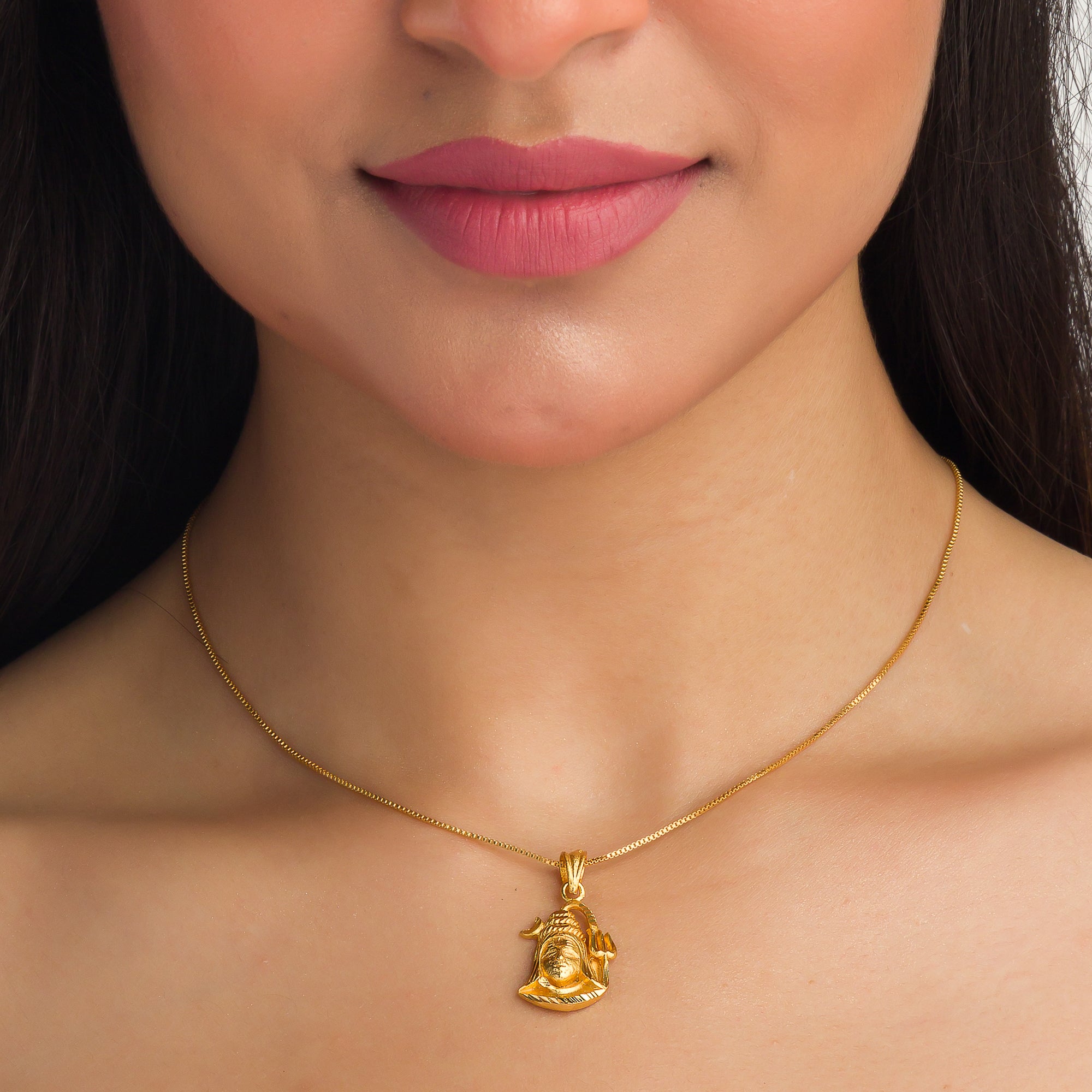 "Gold-tone pendant set featuring Shivji with half moon and trishul, perfect for casual wear."