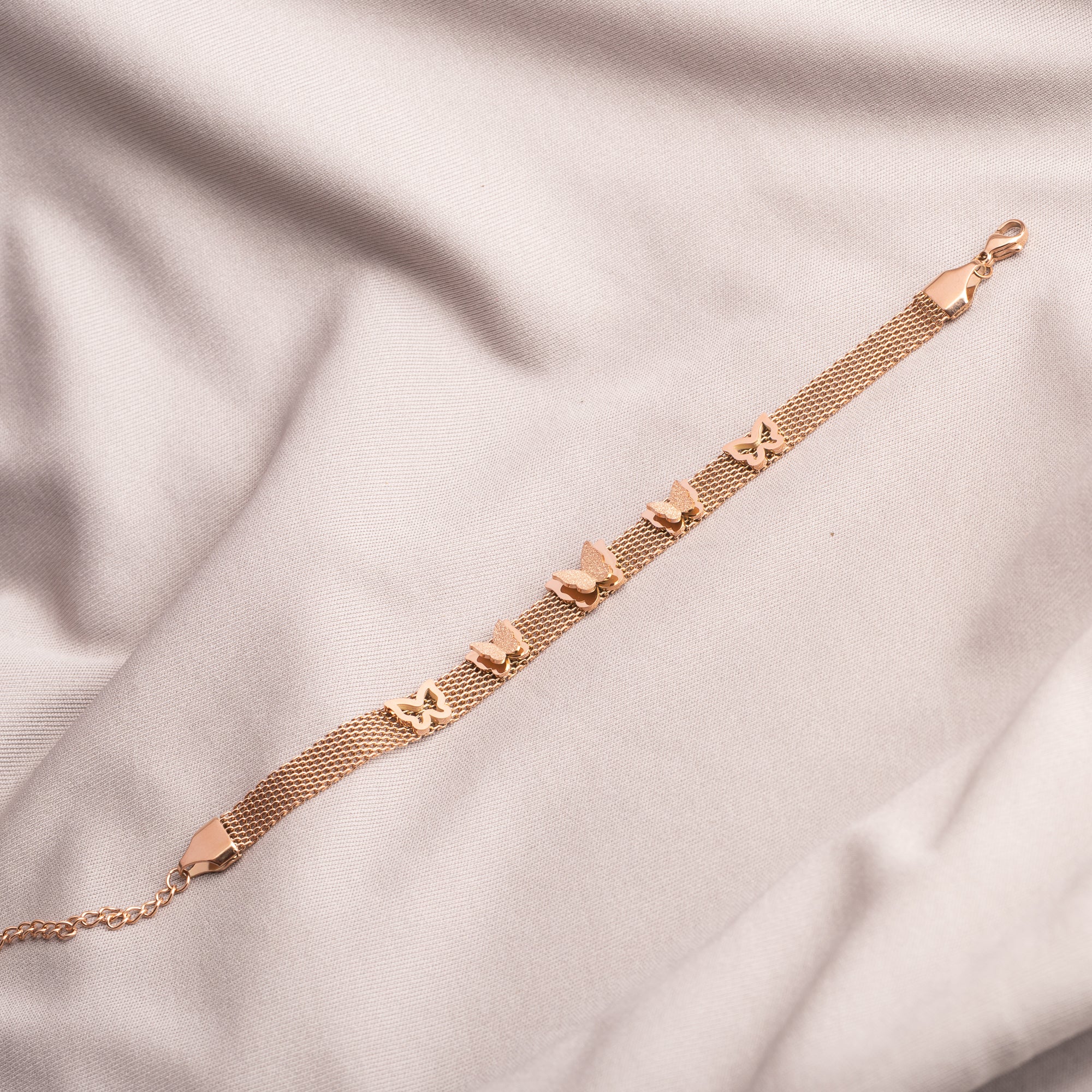 "Rosegold stainless steel bracelet with butterfly details, perfect for casual wear, adding a delicate touch."