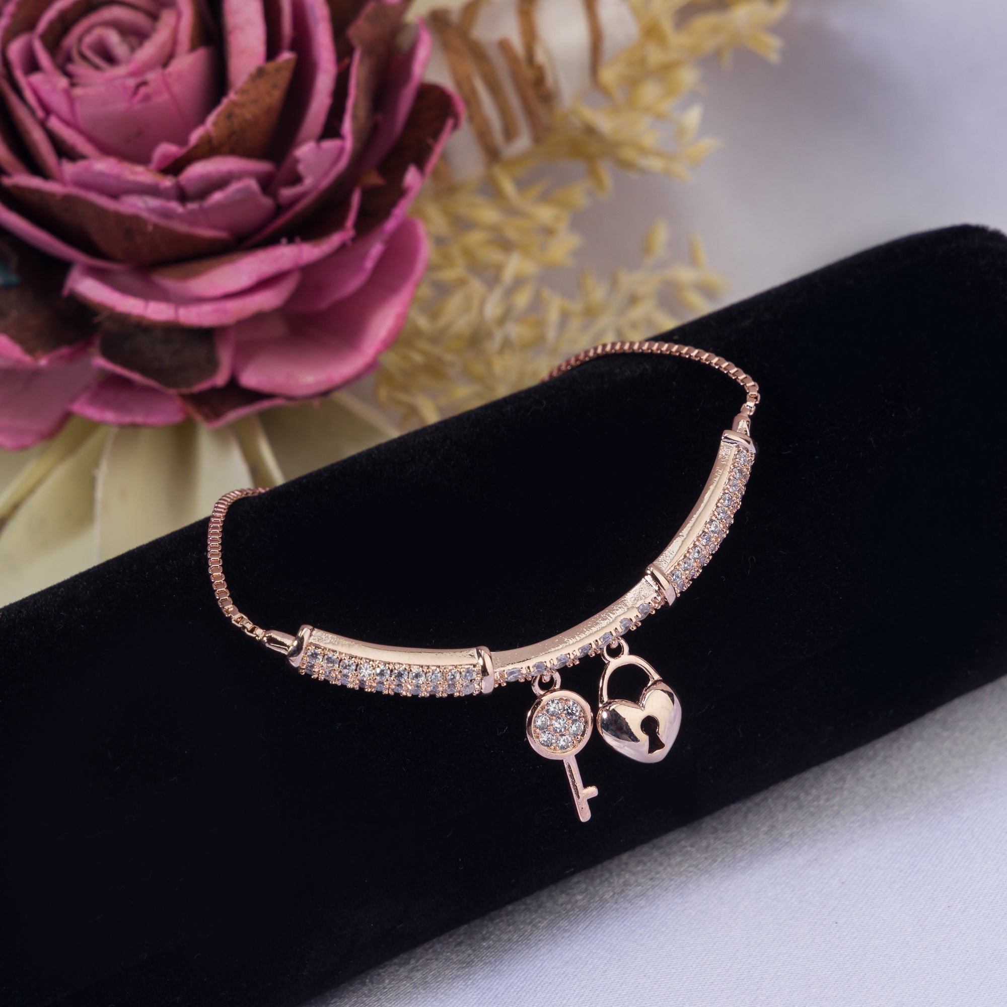 "Trendy lock and key zircon bracelet in rosegold, ideal for party wear, offering a chic and stylish look."