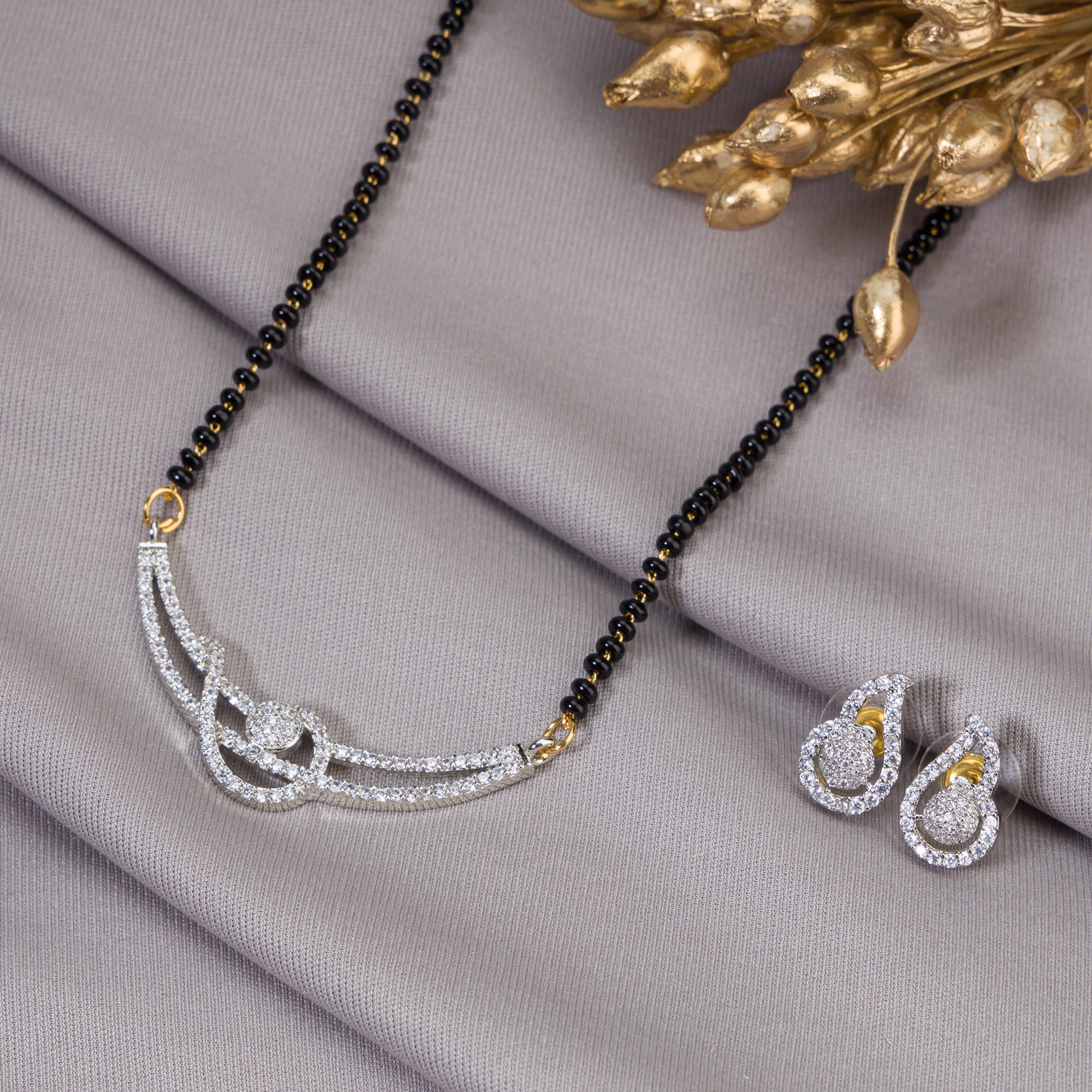 "Black zircon mangalsutra in gold, blending traditional charm with radiant, modern sparkle."