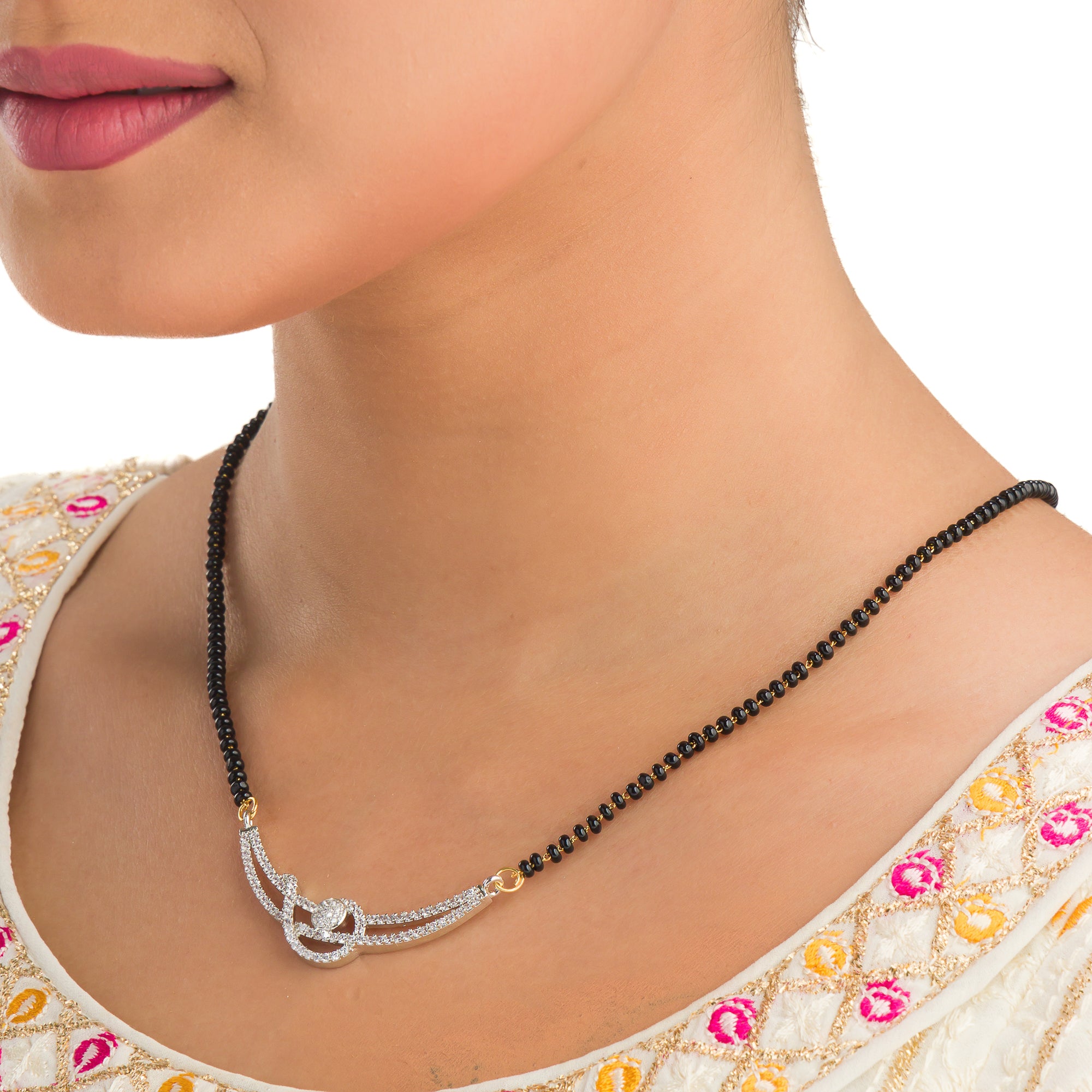 "Black zircon mangalsutra in gold, blending traditional charm with radiant, modern sparkle."
