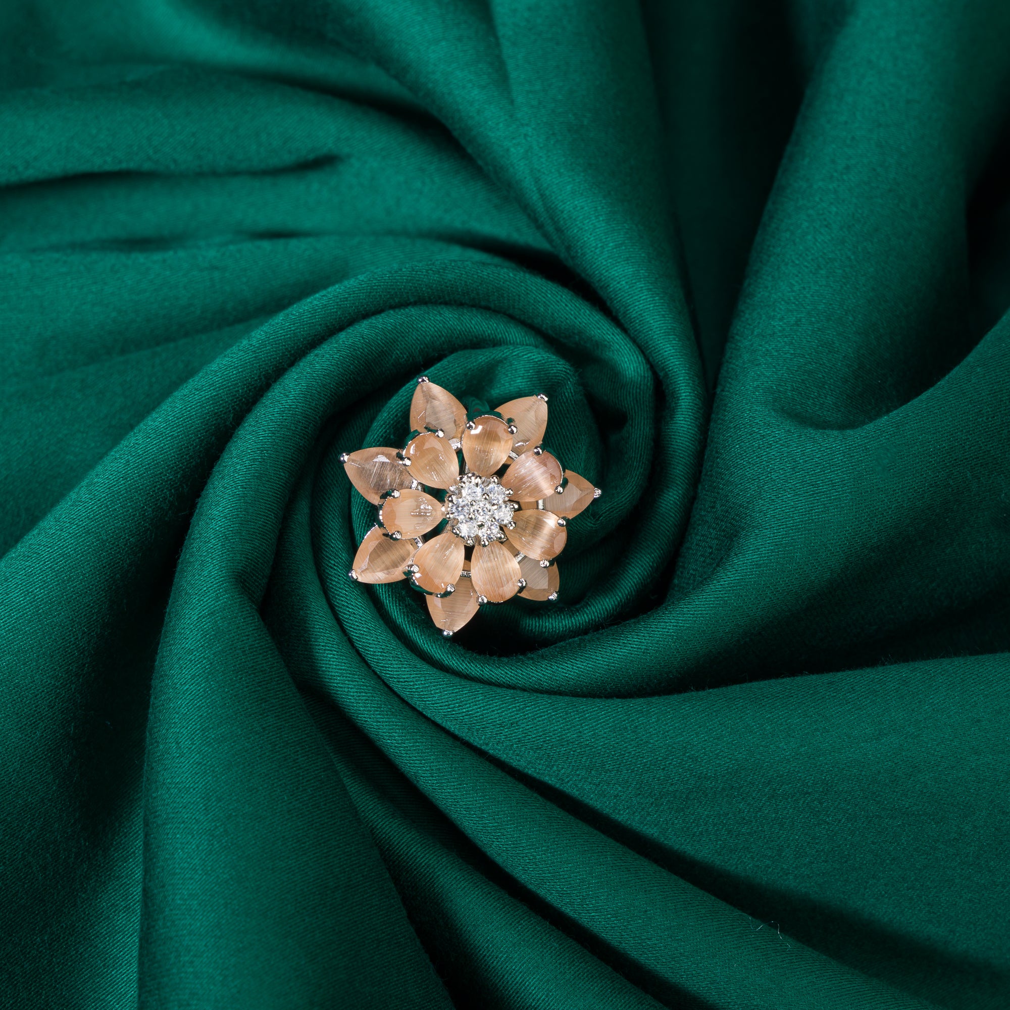 "Salmon zircon finger ring in silver offers a warm, radiant glow with a unique, rosy hue for party wear."