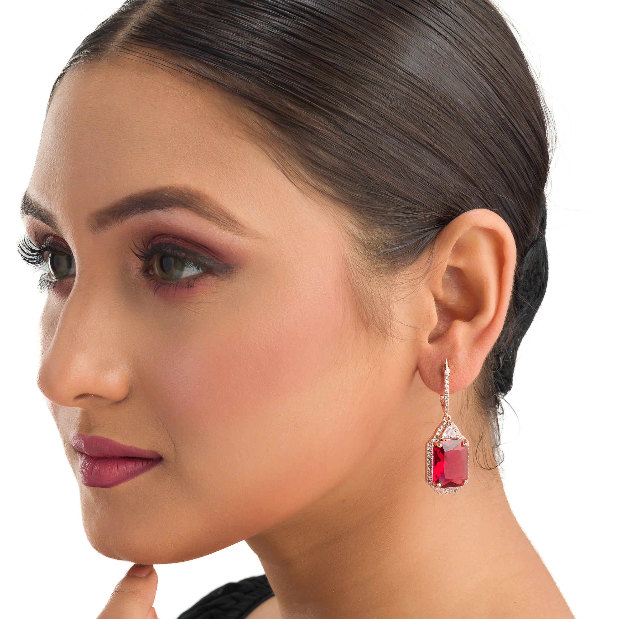 "Dark red zircon dangler earrings in rose gold offer a bold, sophisticated touch for party wear."