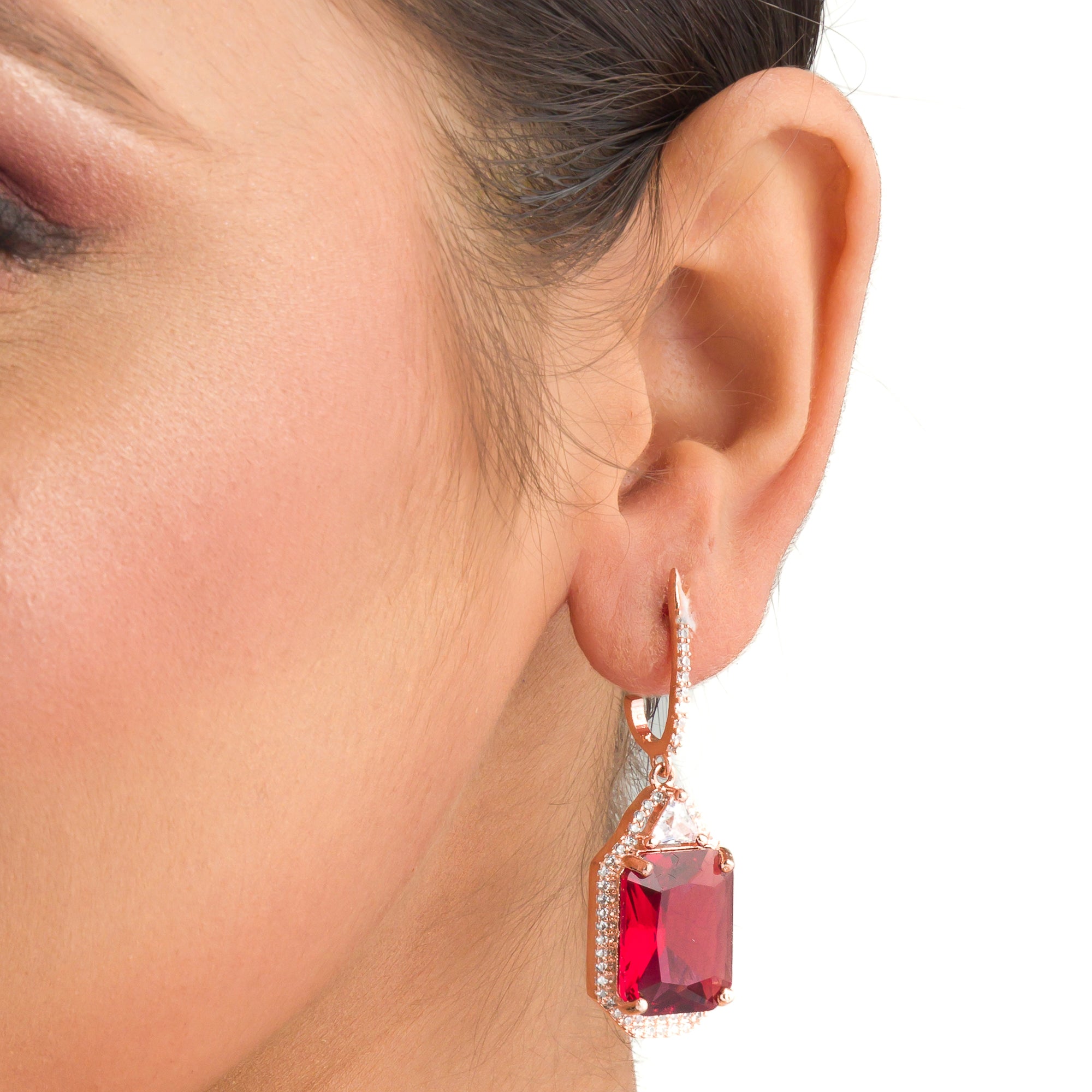 "Dark red zircon dangler earrings in rose gold offer a bold, sophisticated touch for party wear."
