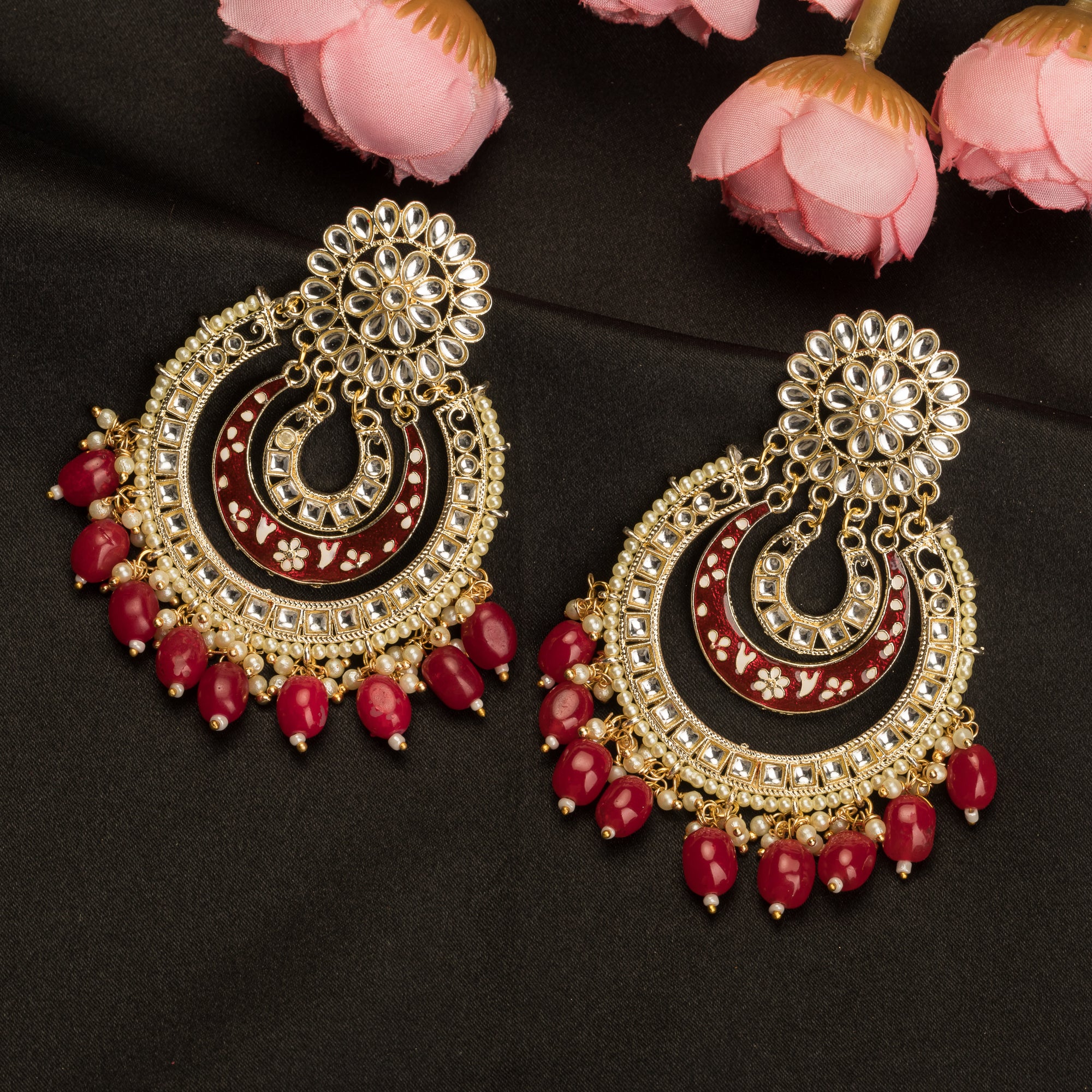 1. "Red kundan dangler earrings in gold add a vibrant touch to your festive look. Perfect for celebrations."