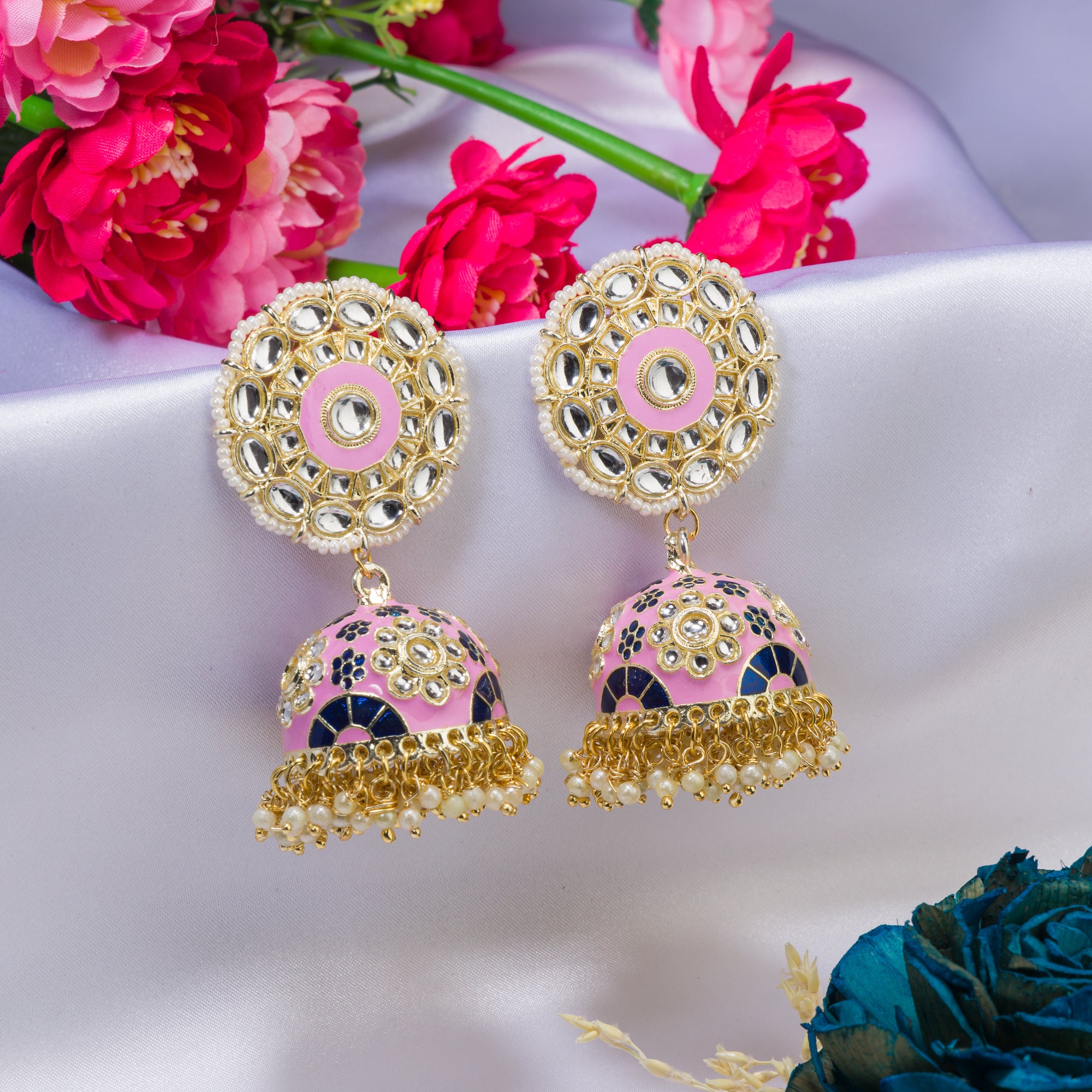 "Orchid minakari jhumka earrings in gold tone showcase intricate, vibrant designs with timeless elegance for festivals."