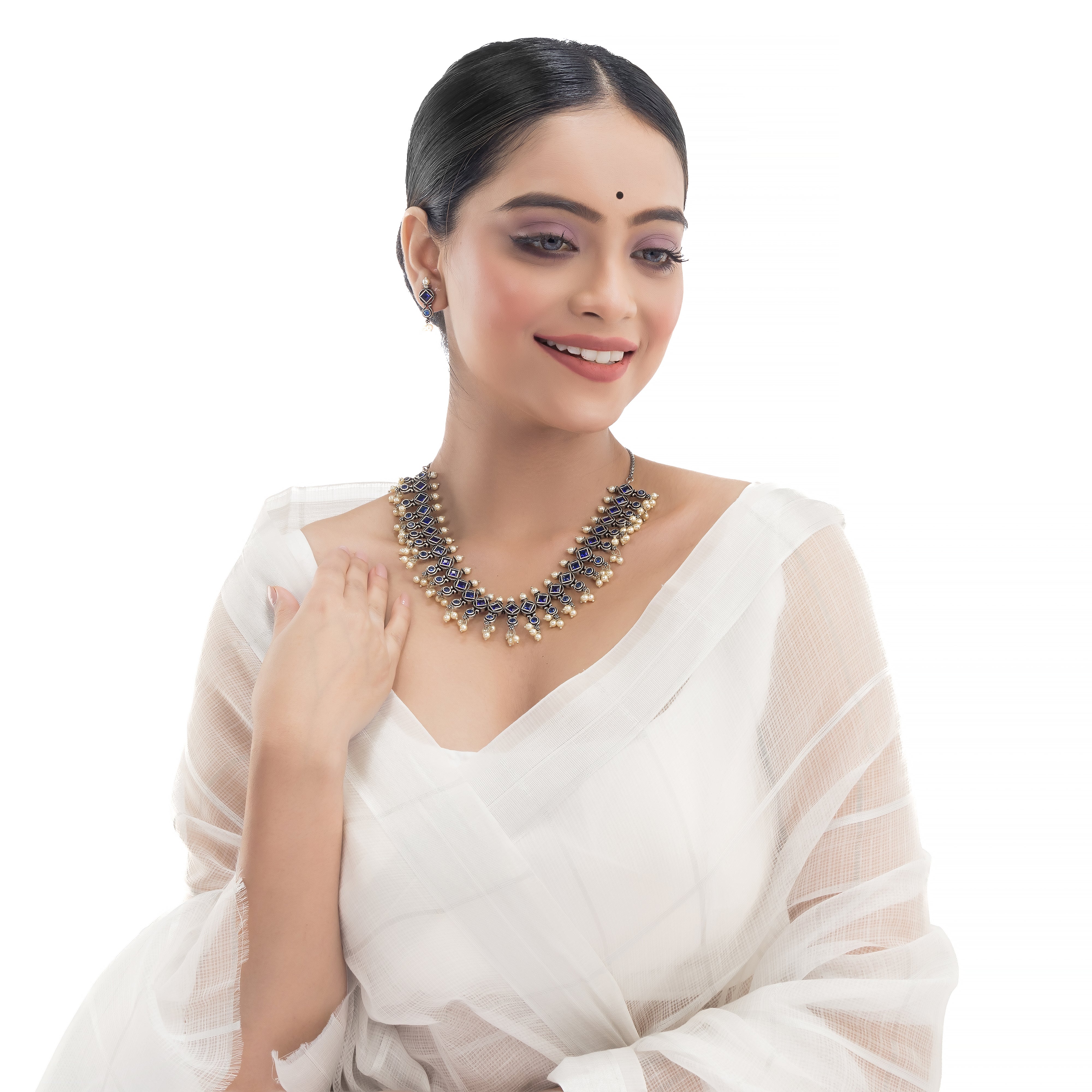 "Zircon stud earrings in silver offer intricate detailing and radiant sparkle for a traditional, elegant party wear look."