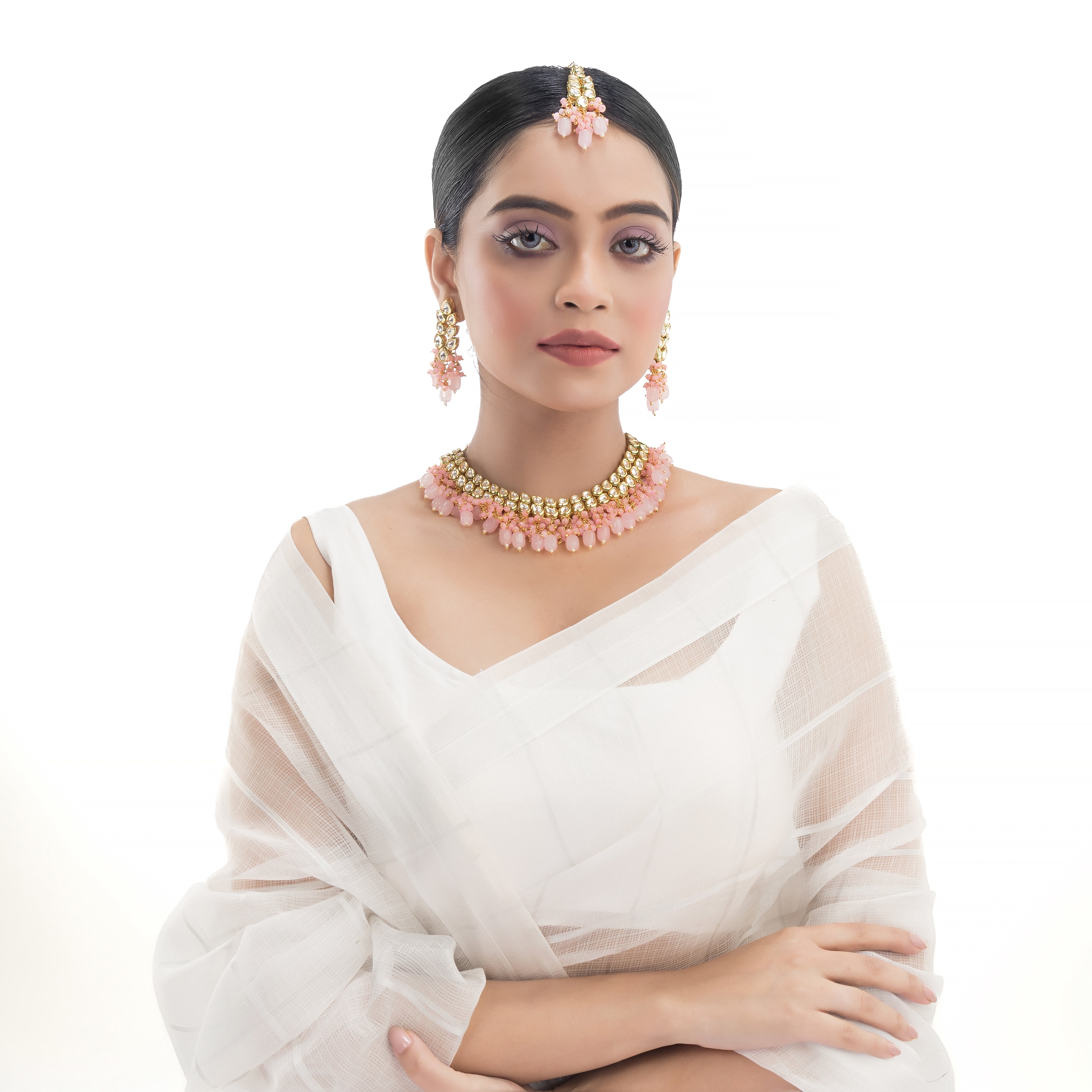 "Zircon stud earrings in silver offer intricate detailing and radiant sparkle for a traditional, elegant party wear look."