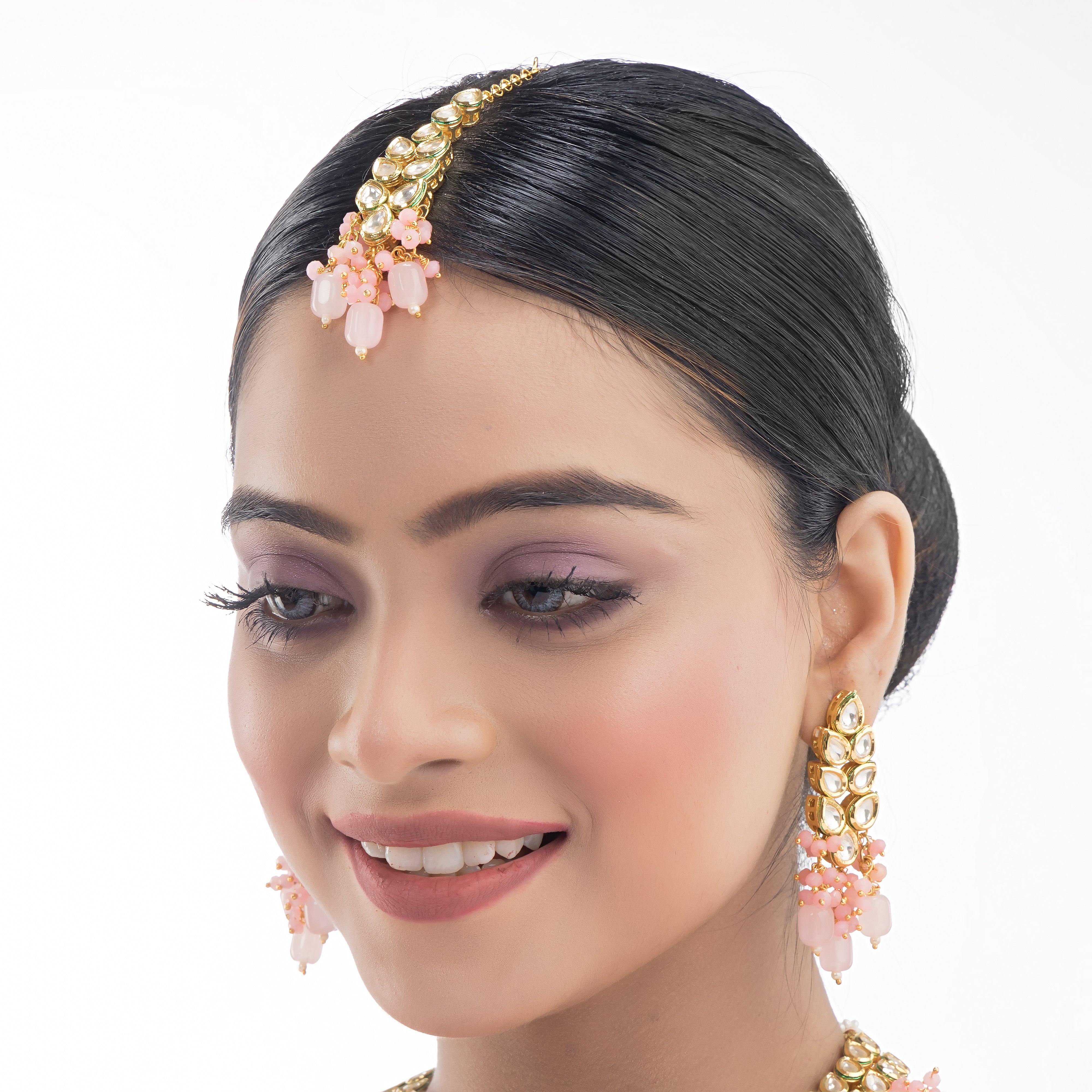 "Zircon stud earrings in silver offer intricate detailing and radiant sparkle for a traditional, elegant party wear look."