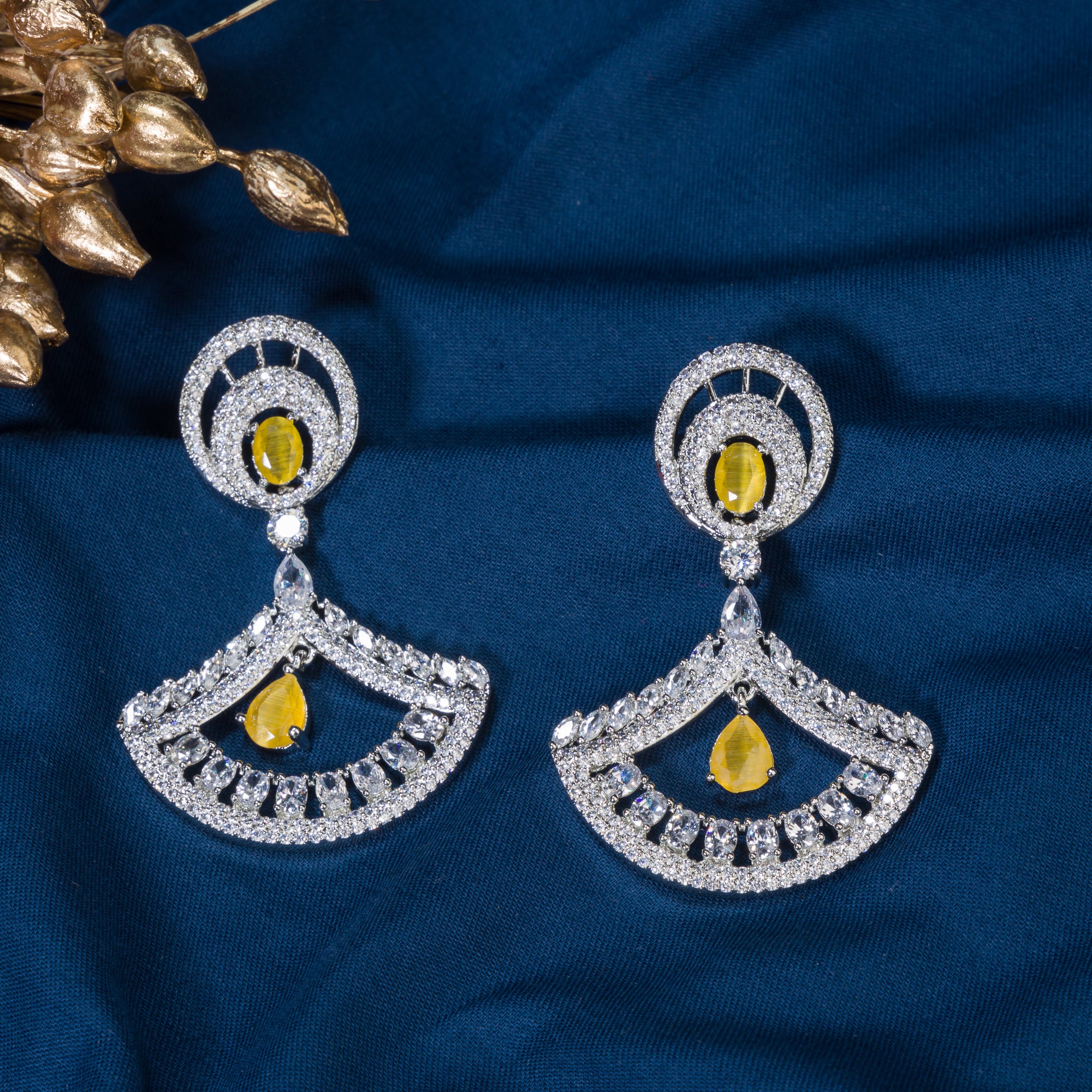 1. Yellow zircon earrings paired with clear zircon create a dazzling contrast of vibrant and sparkling brilliance for party wear.