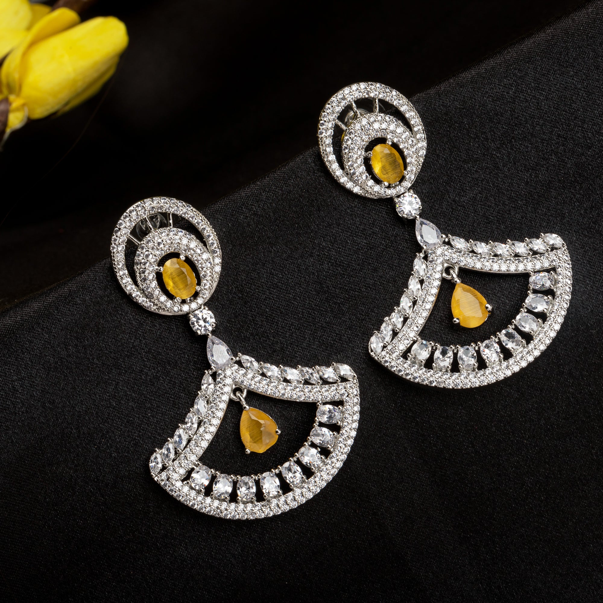 1. Yellow zircon earrings paired with clear zircon create a dazzling contrast of vibrant and sparkling brilliance for party wear.