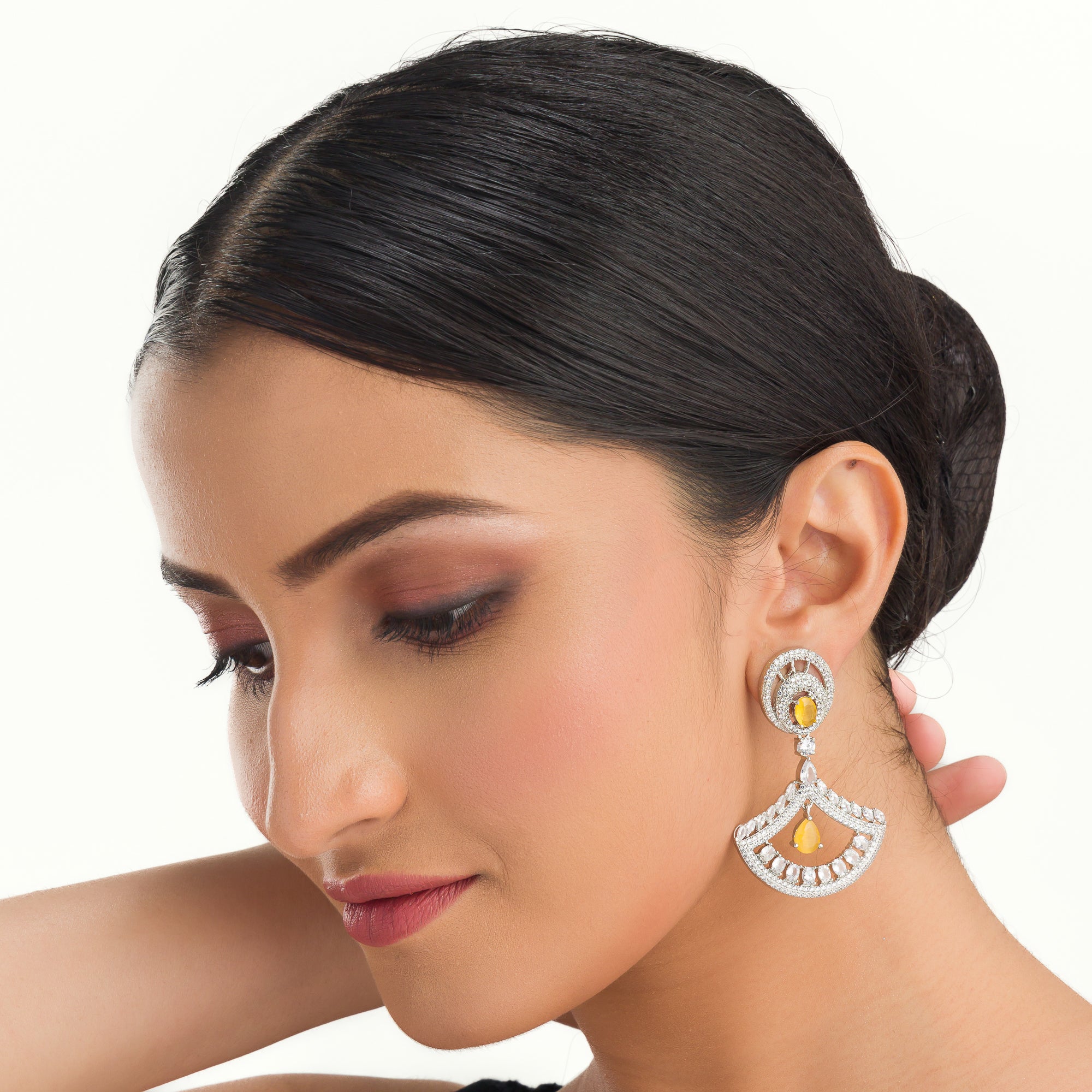 1. Yellow zircon earrings paired with clear zircon create a dazzling contrast of vibrant and sparkling brilliance for party wear.