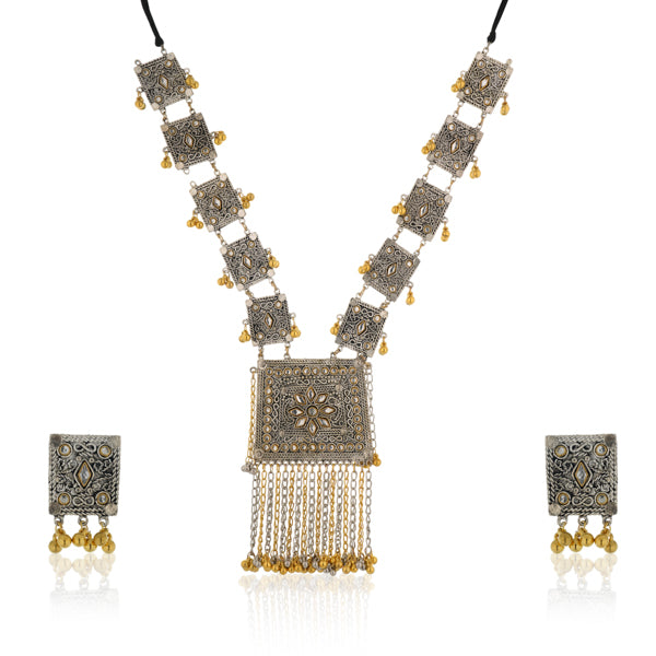 "Black kundan earrings with gold polish and matching maangtika exude regal sophistication."