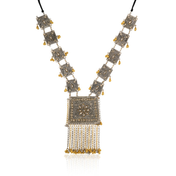 "Black kundan earrings with gold polish and matching maangtika exude regal sophistication."