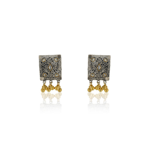 "Black kundan earrings with gold polish and matching maangtika exude regal sophistication."