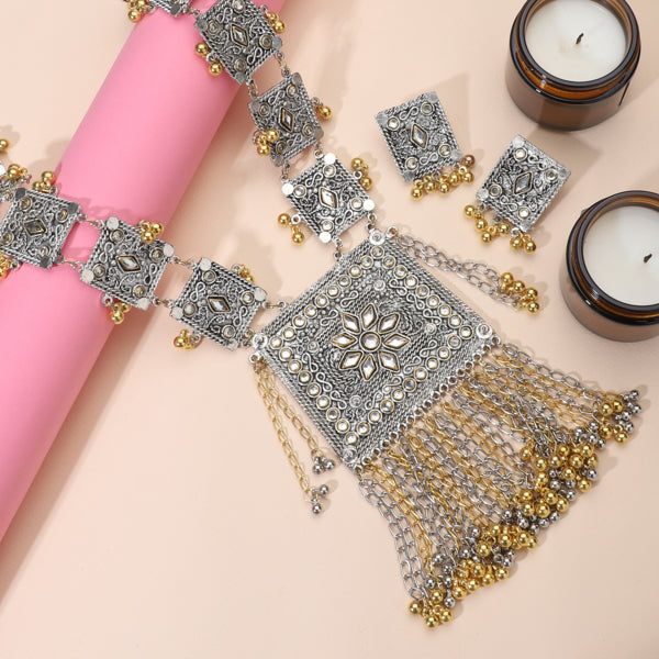 "Black kundan earrings with gold polish and matching maangtika exude regal sophistication."