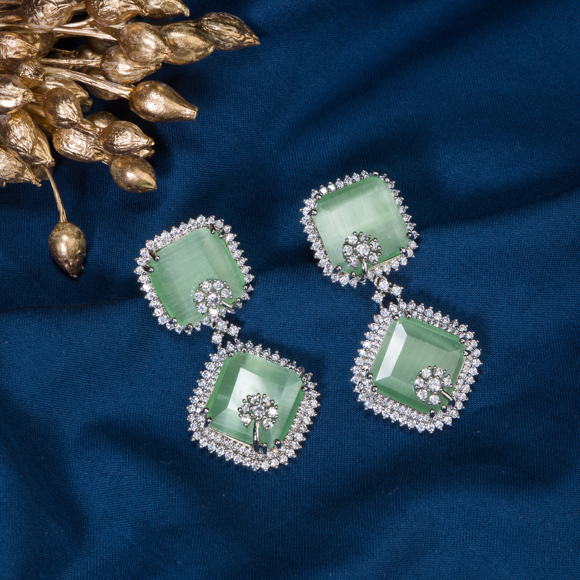 1. "Light green zircon dangler earrings offer delicate sparkle and serene elegance for any occasion."
