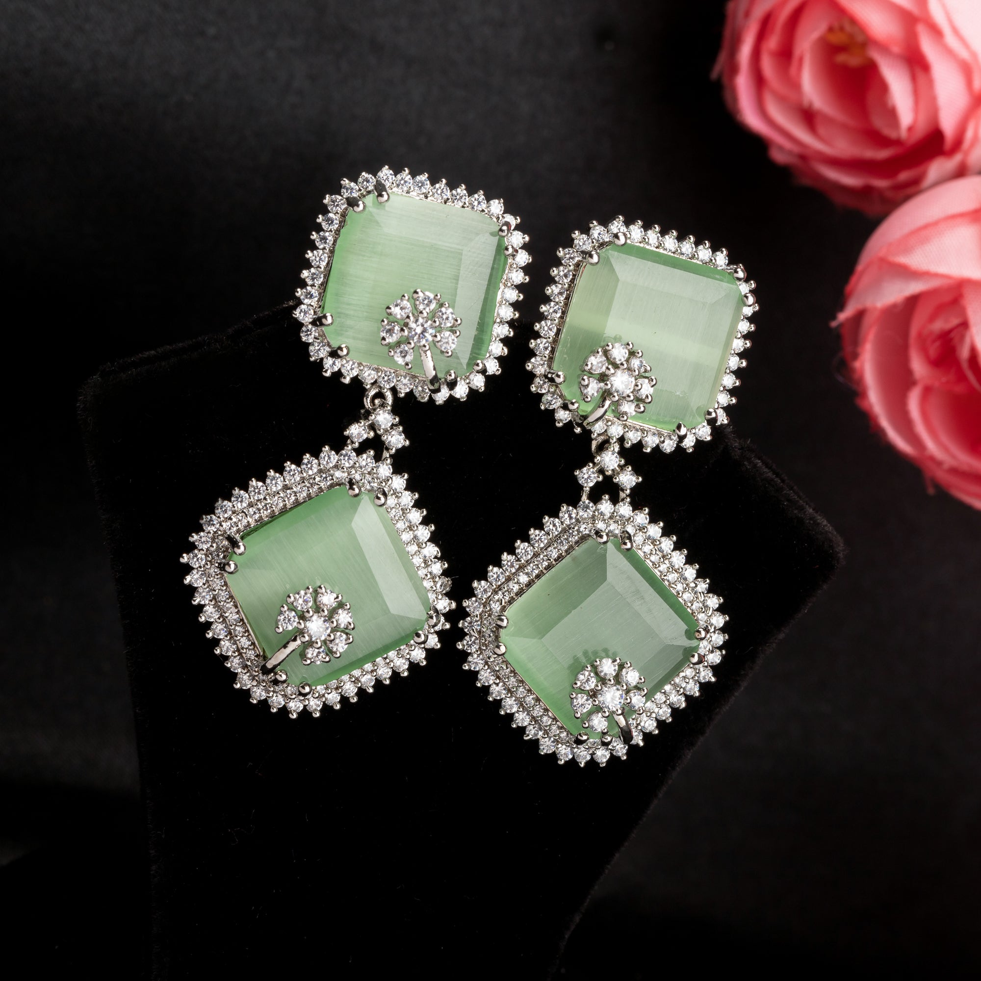 1. "Light green zircon dangler earrings offer delicate sparkle and serene elegance for any occasion."