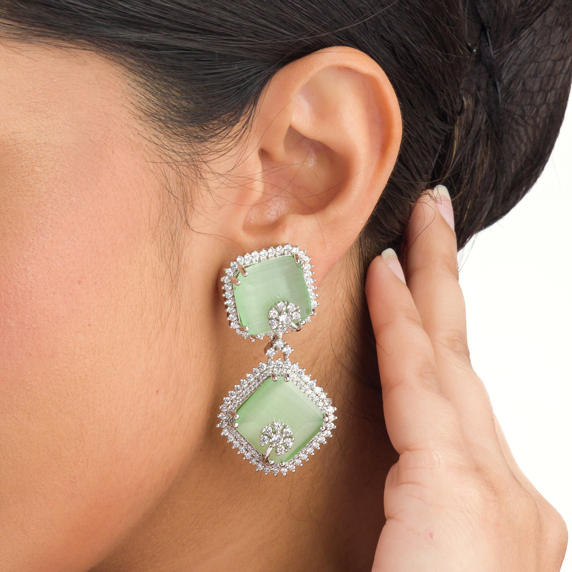 1. "Light green zircon dangler earrings offer delicate sparkle and serene elegance for any occasion."