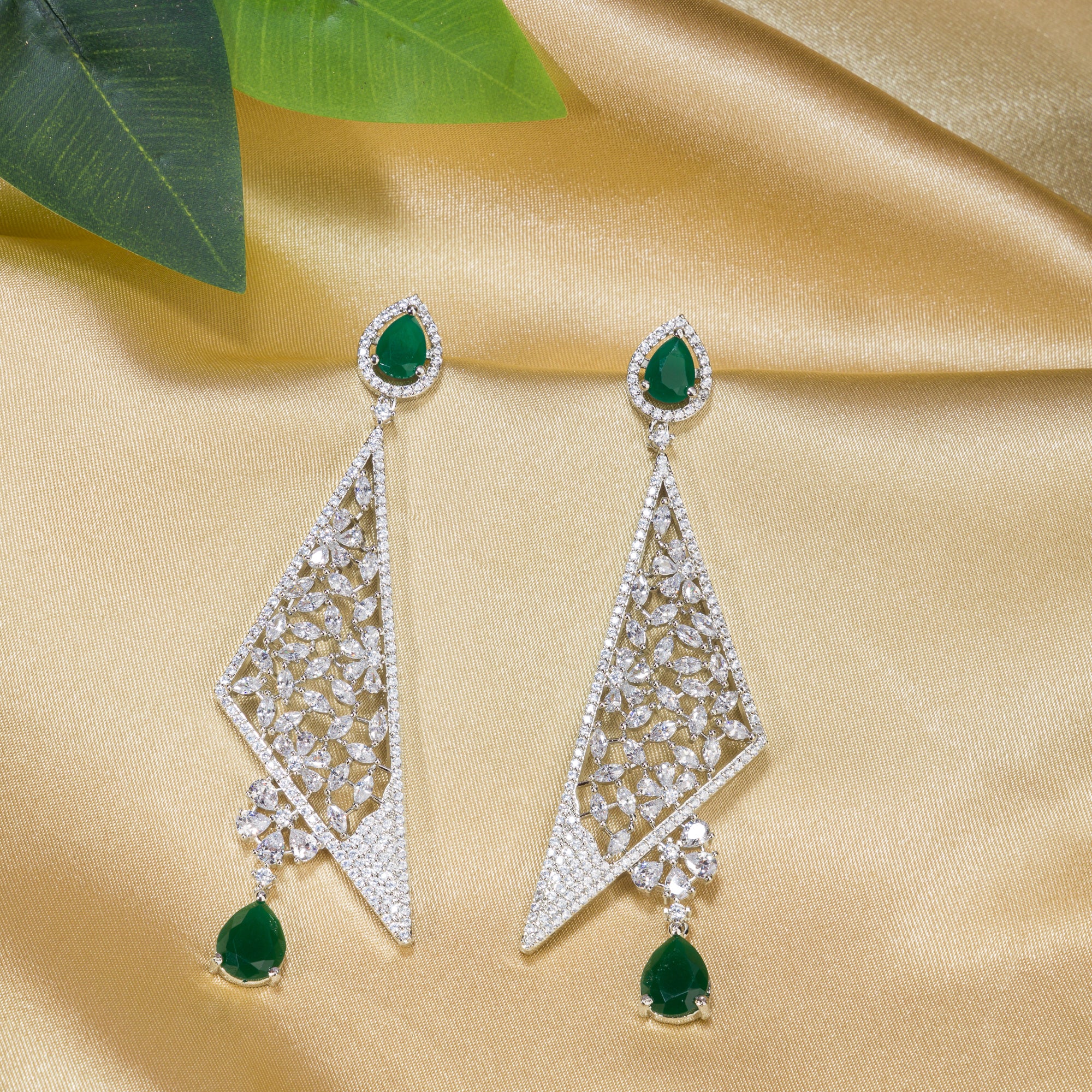 "Vibrant green zircon dangler earrings radiate rich, emerald-like sparkle and elegance."