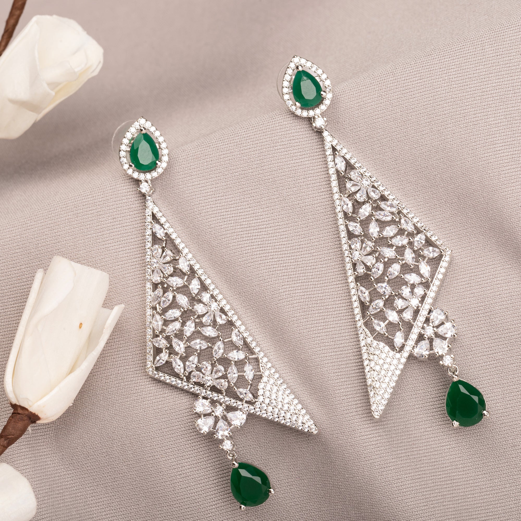 "Vibrant green zircon dangler earrings radiate rich, emerald-like sparkle and elegance."