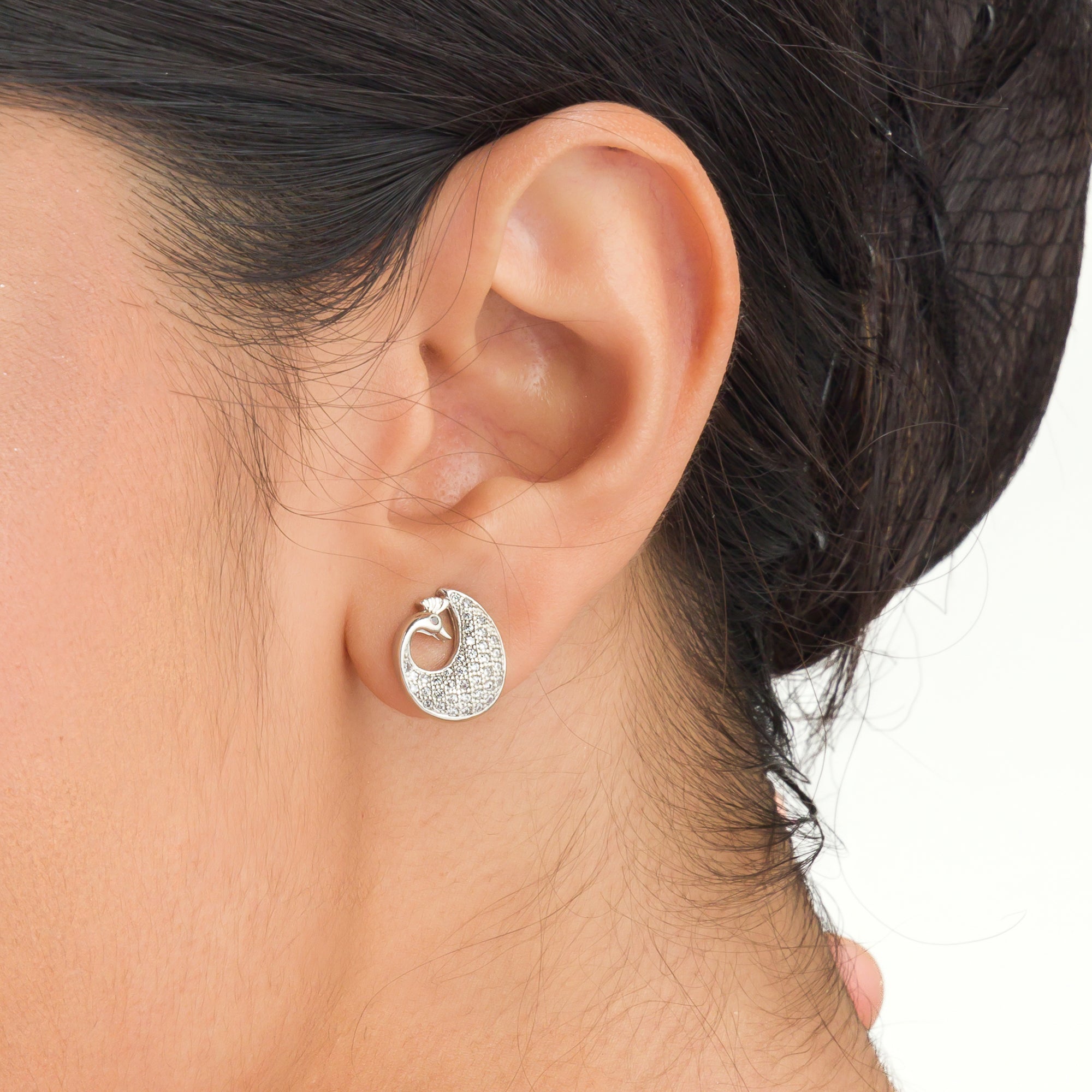 "Elegant peacock-shaped zircon studs add whimsical beauty and sparkle to your look."