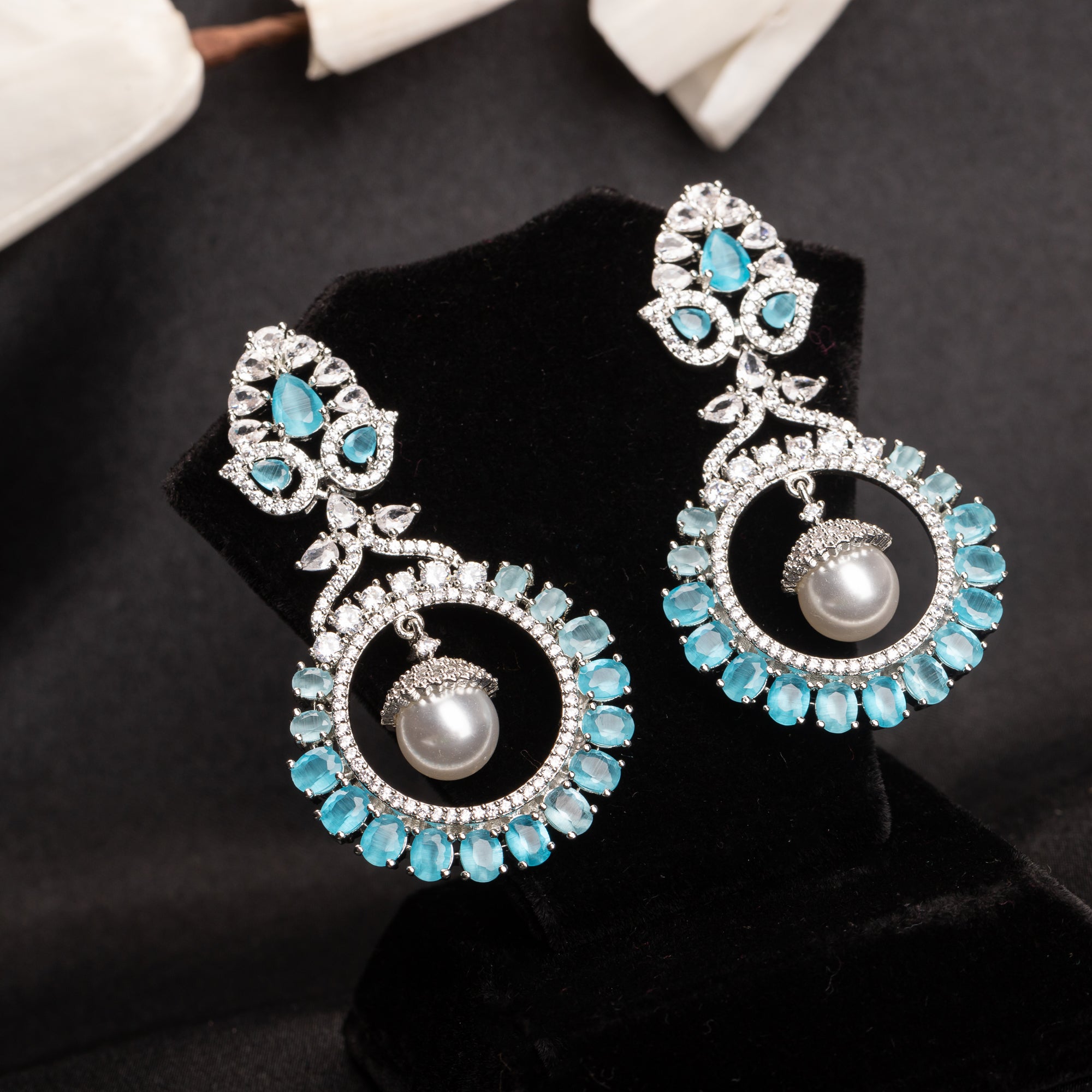 "Aqua zircon earrings with a captivating hue bring elegance and sparkle to your look."