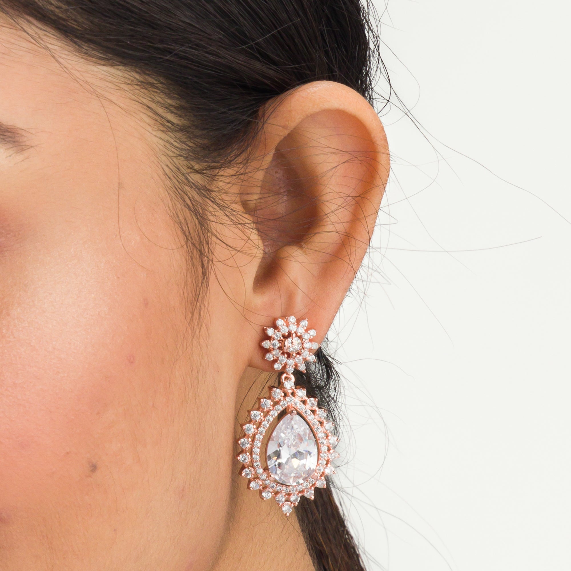 "Rose gold zircon earrings add elegance and sparkle to any look with timeless shine."