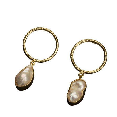 "Golden earrings with white uncut stones blend classic elegance with modern flair."