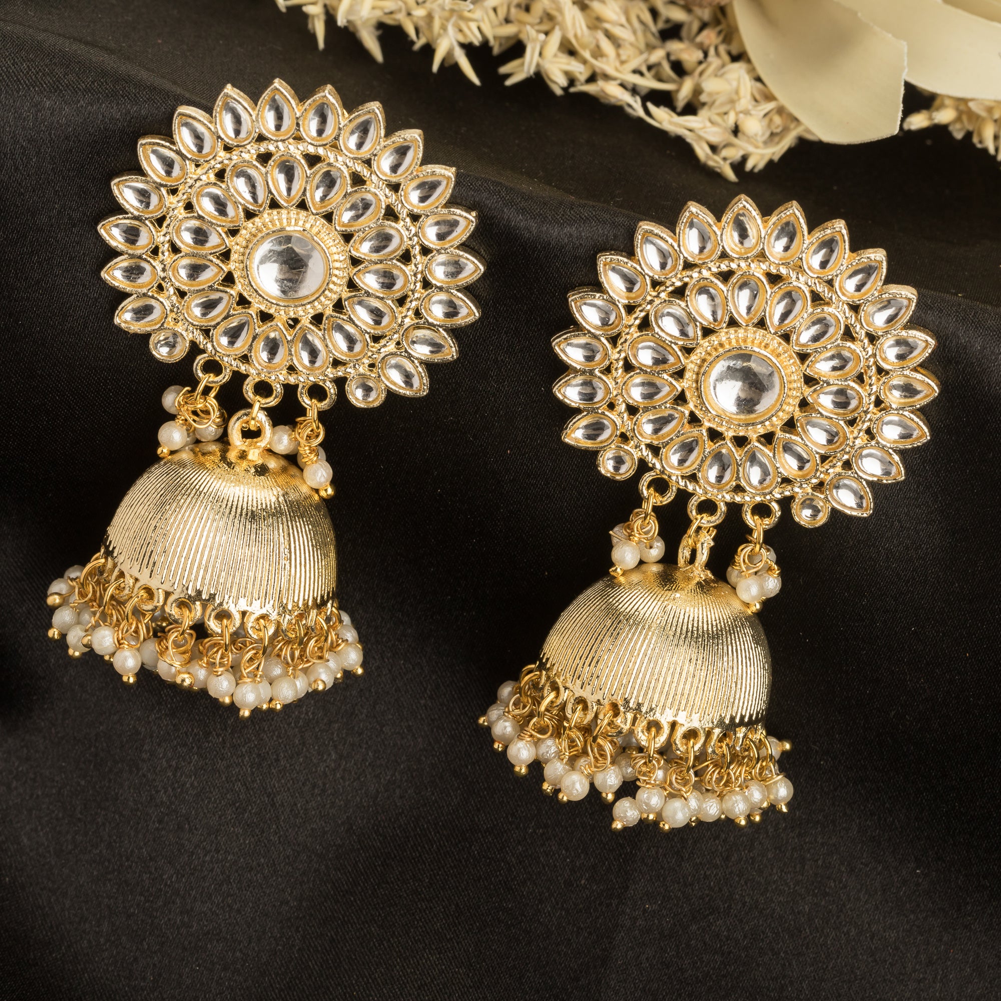 "Pearl and gold jhumka combines classic elegance with opulent shine for a festive look."