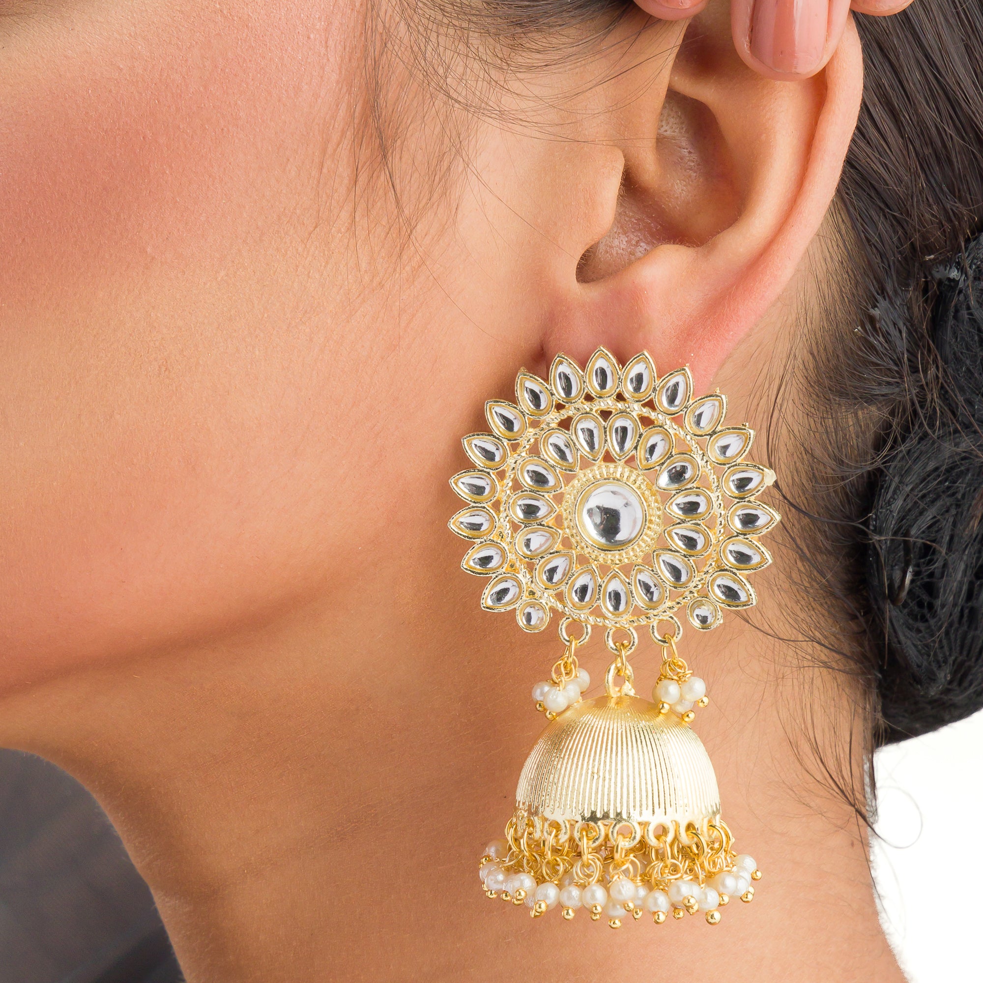 "Pearl and gold jhumka combines classic elegance with opulent shine for a festive look."