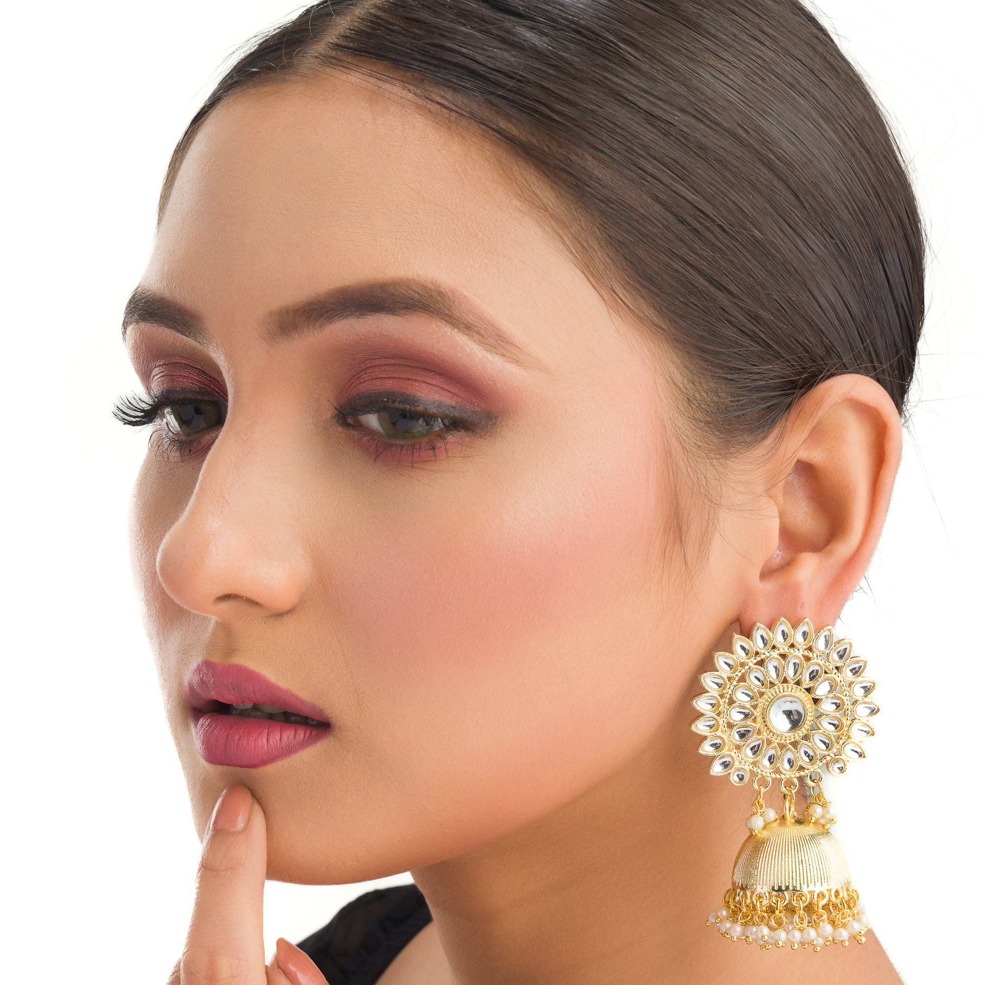 "Pearl and gold jhumka combines classic elegance with opulent shine for a festive look."