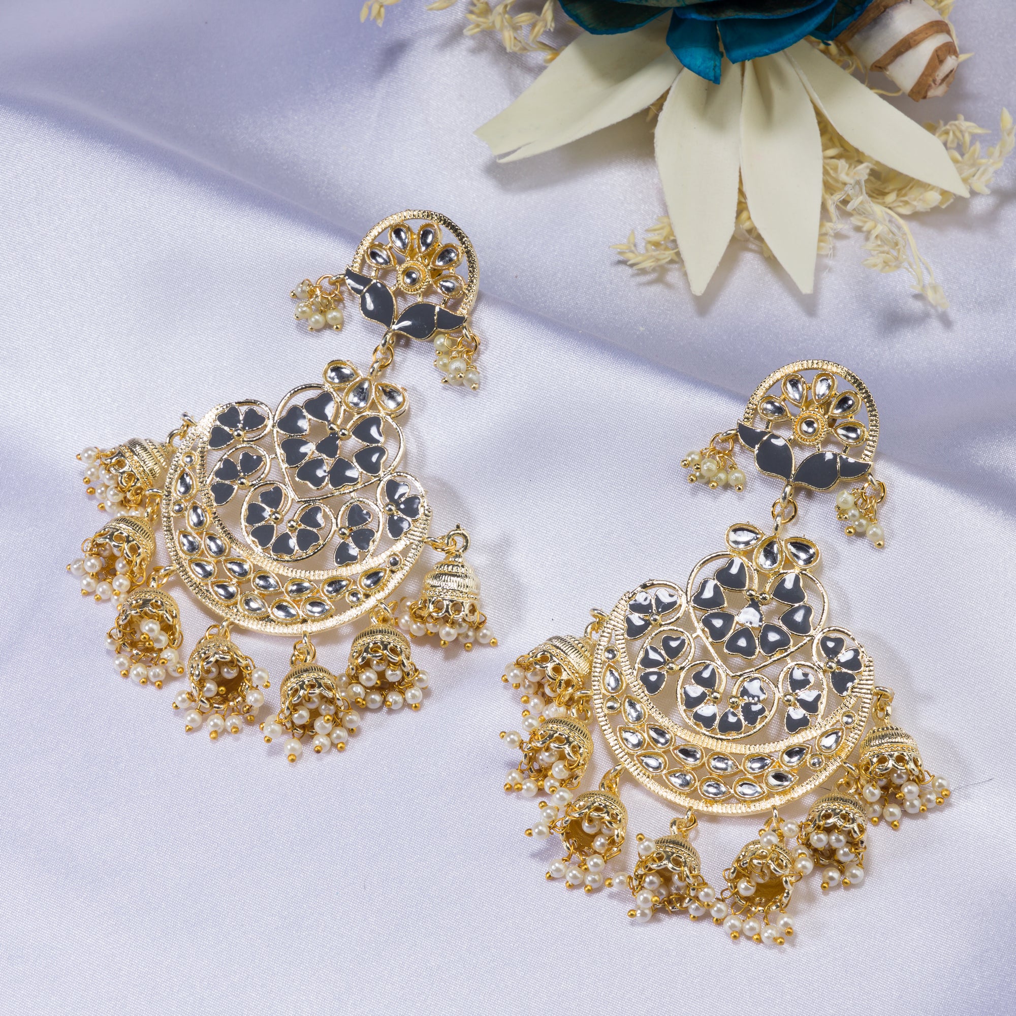 "Kundan earrings with white pearls offer a regal, timeless charm for any occasion."