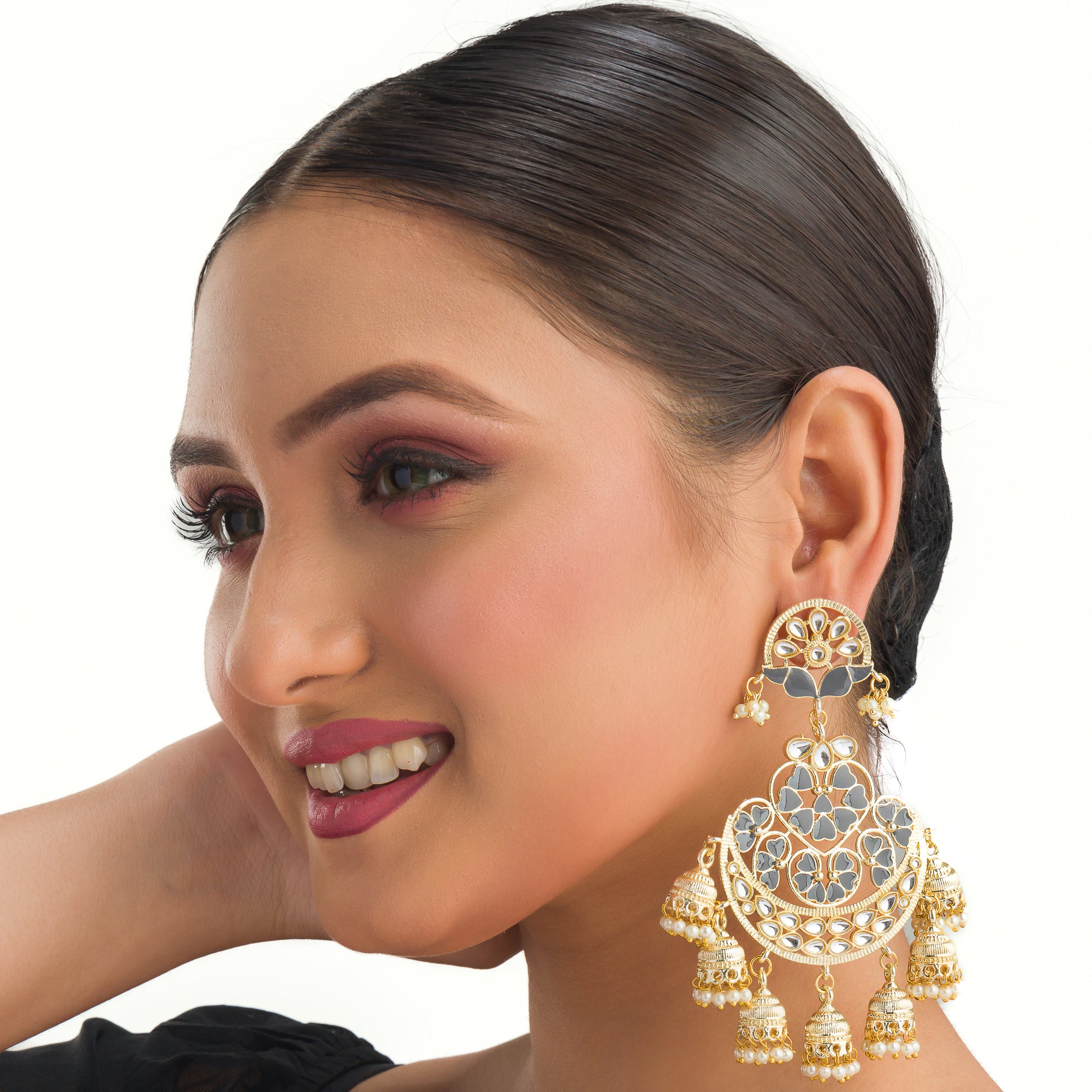 "Kundan earrings with white pearls offer a regal, timeless charm for any occasion."