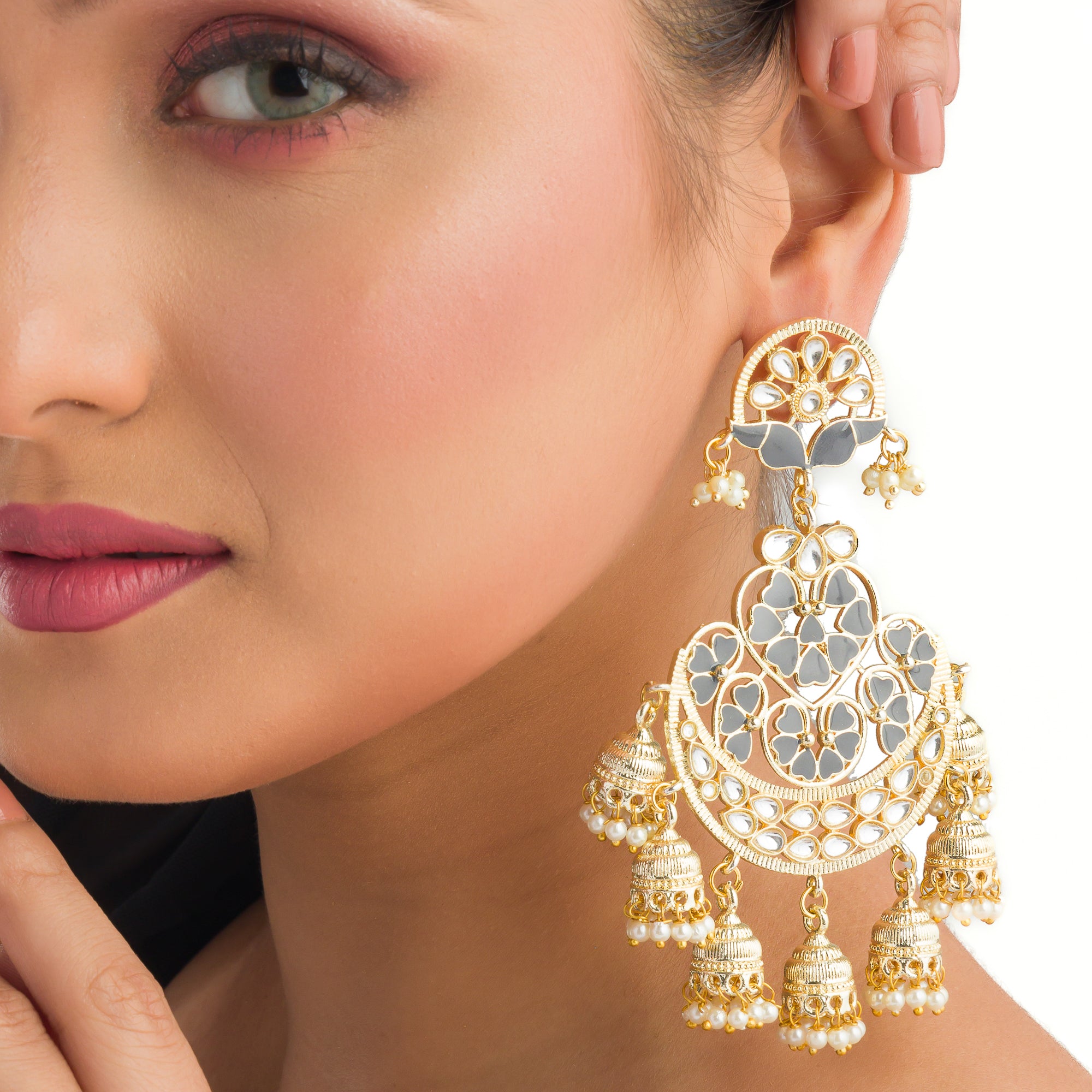 "Kundan earrings with white pearls offer a regal, timeless charm for any occasion."