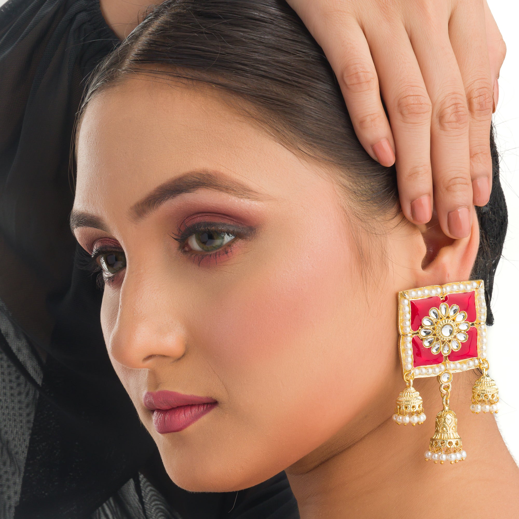 1. "Red square gold jhumka blends bold color and classic elegance for a striking look."