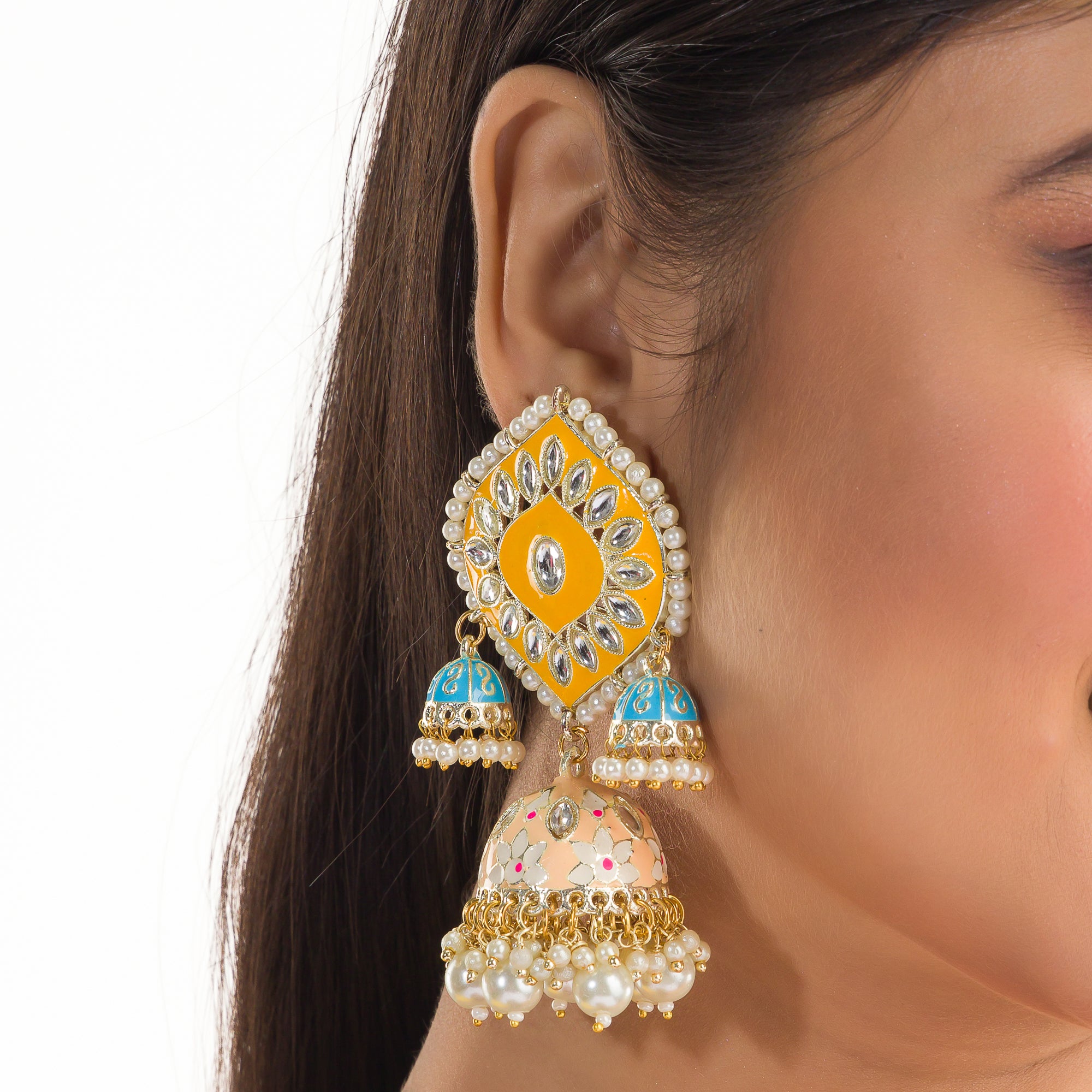 "Yellow and blue gold jhumka earrings blend bold colors with classic elegance for a striking look."