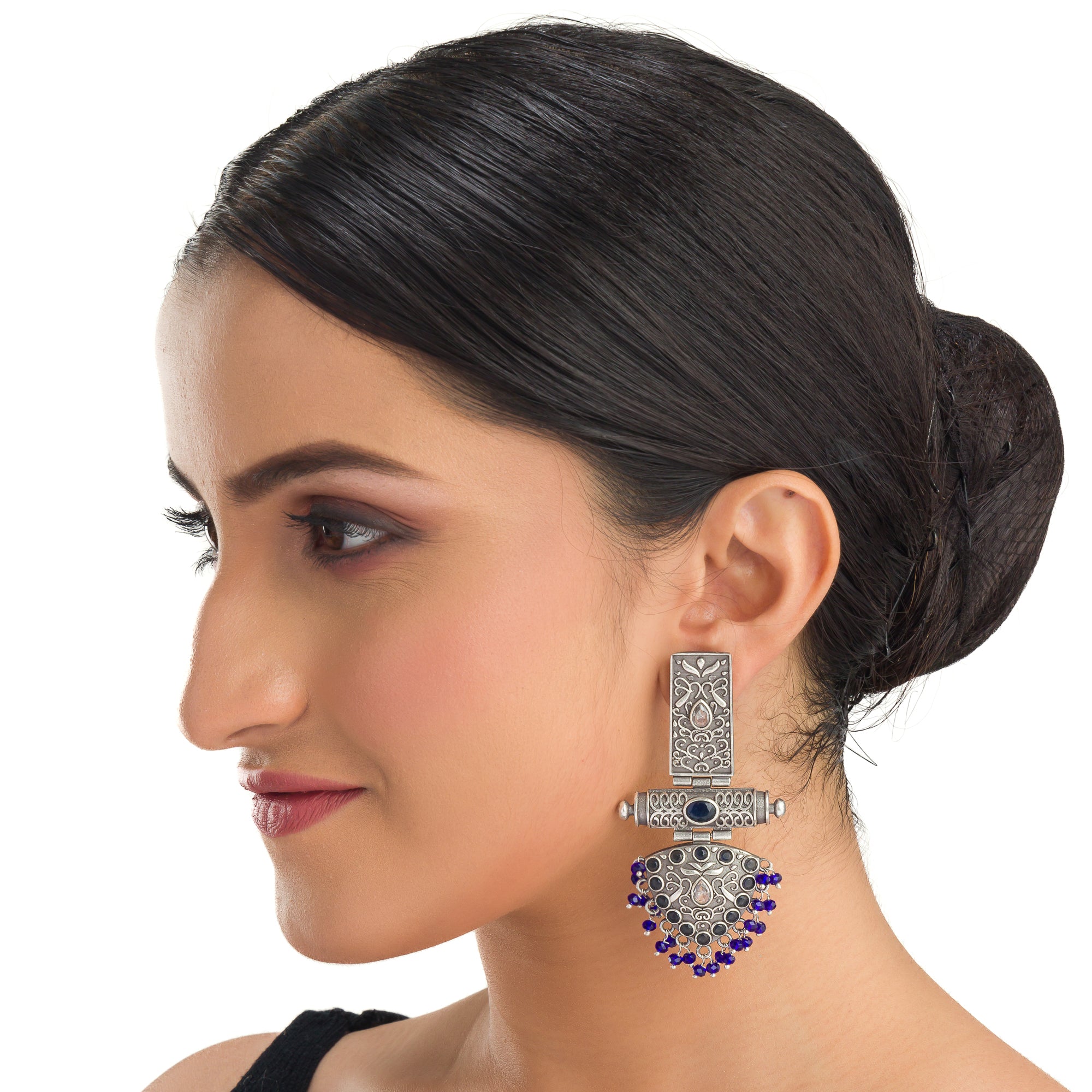 "Oxidized earrings with blue beads offer a unique vintage touch and a pop of color."