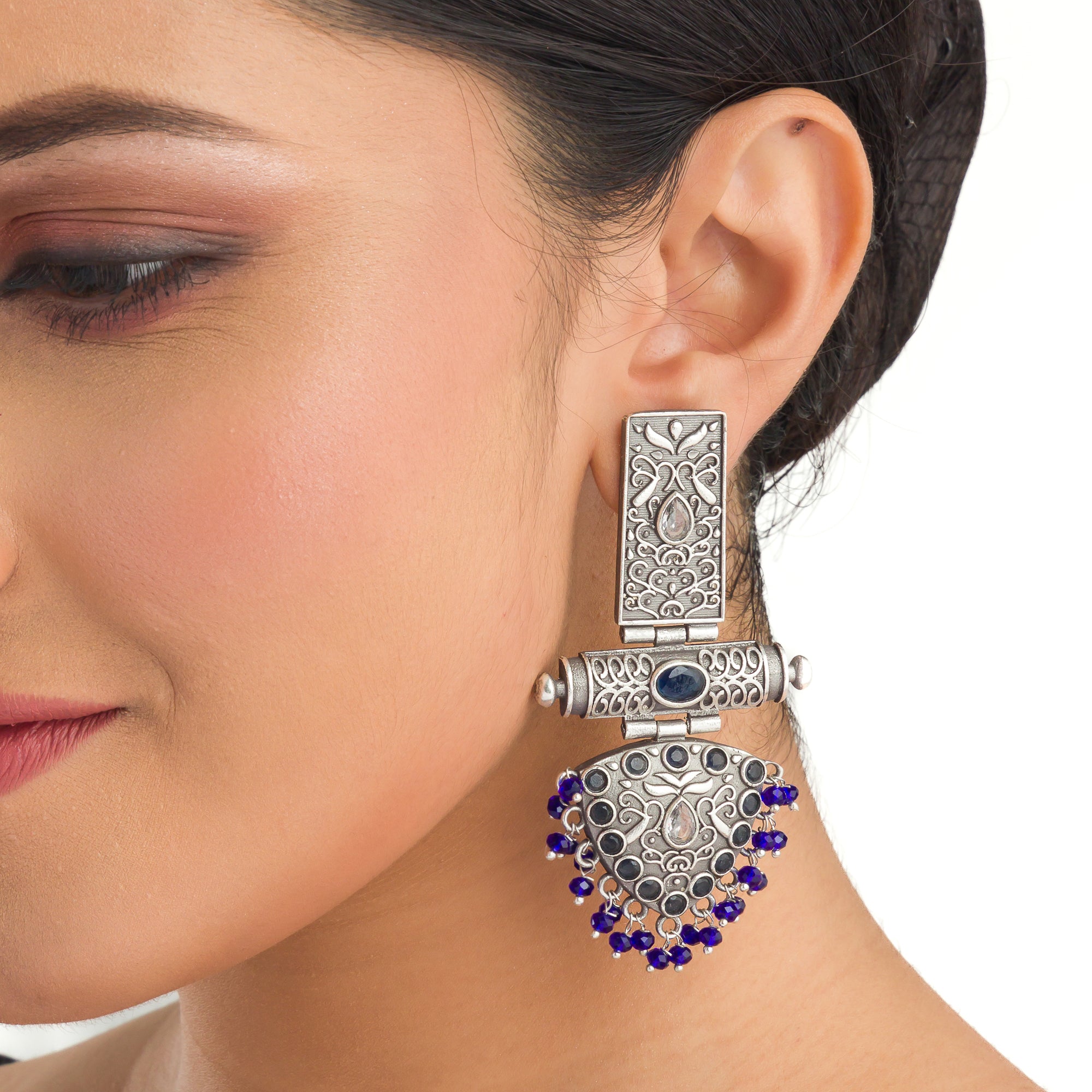 "Oxidized earrings with blue beads offer a unique vintage touch and a pop of color."