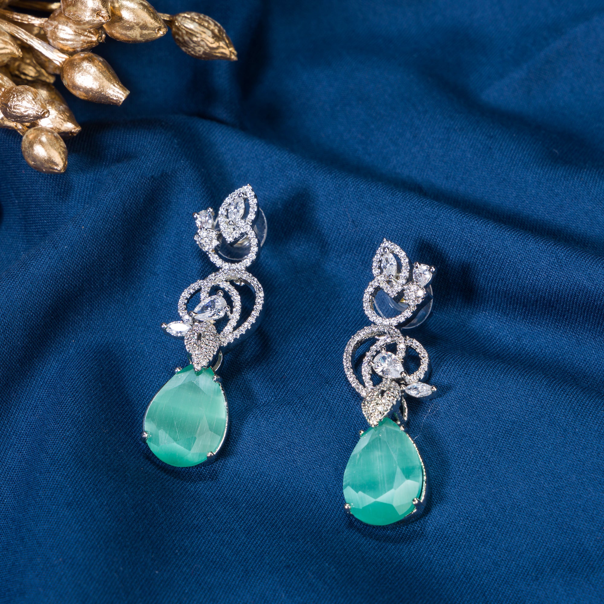 1. "Light green zircon earrings sparkle delicately, adding serene elegance to your look."